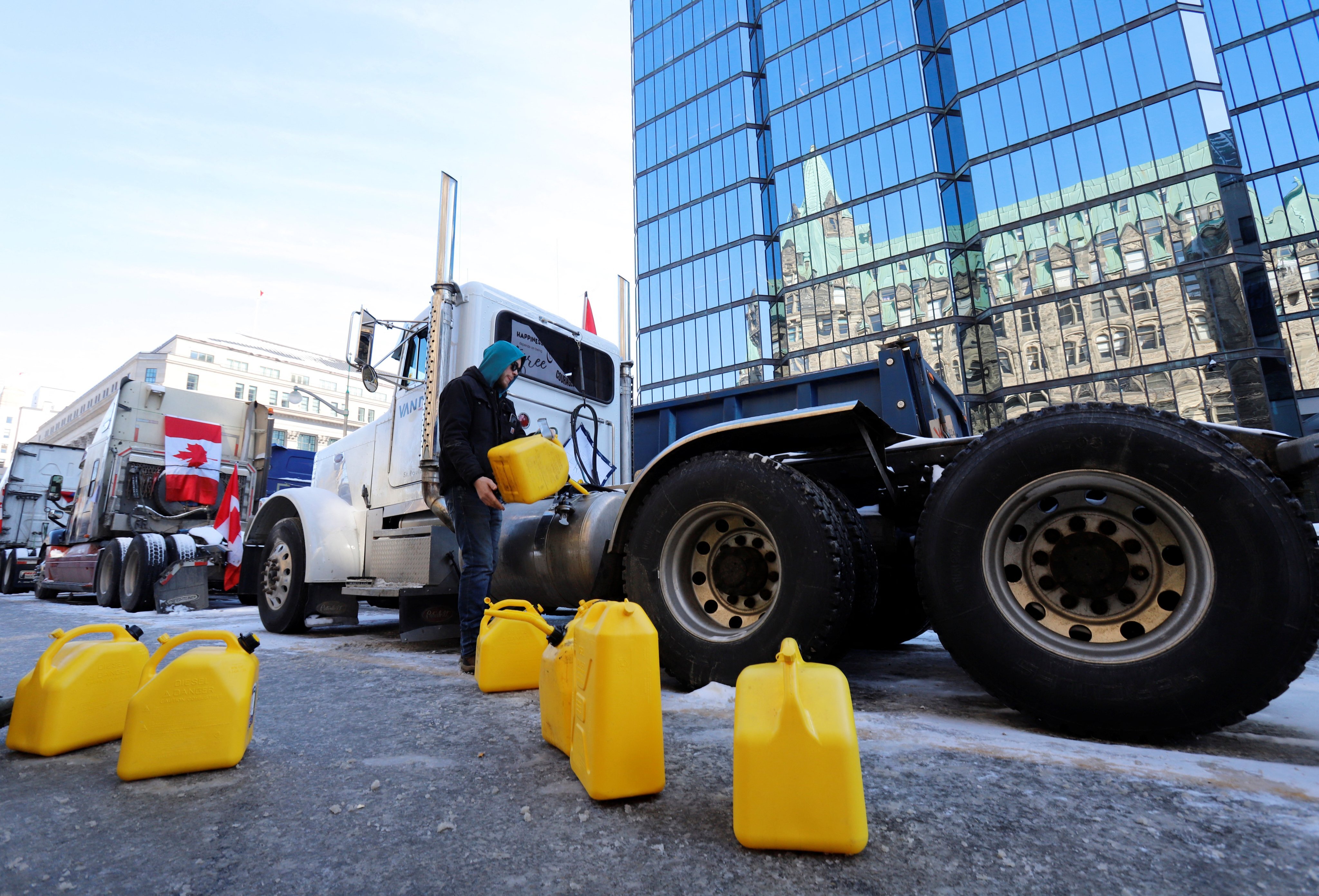 A person fuels a truck on Monday after police said they would be targeting the protestors’ fuel supply in Ottawa. Photo: Reuters