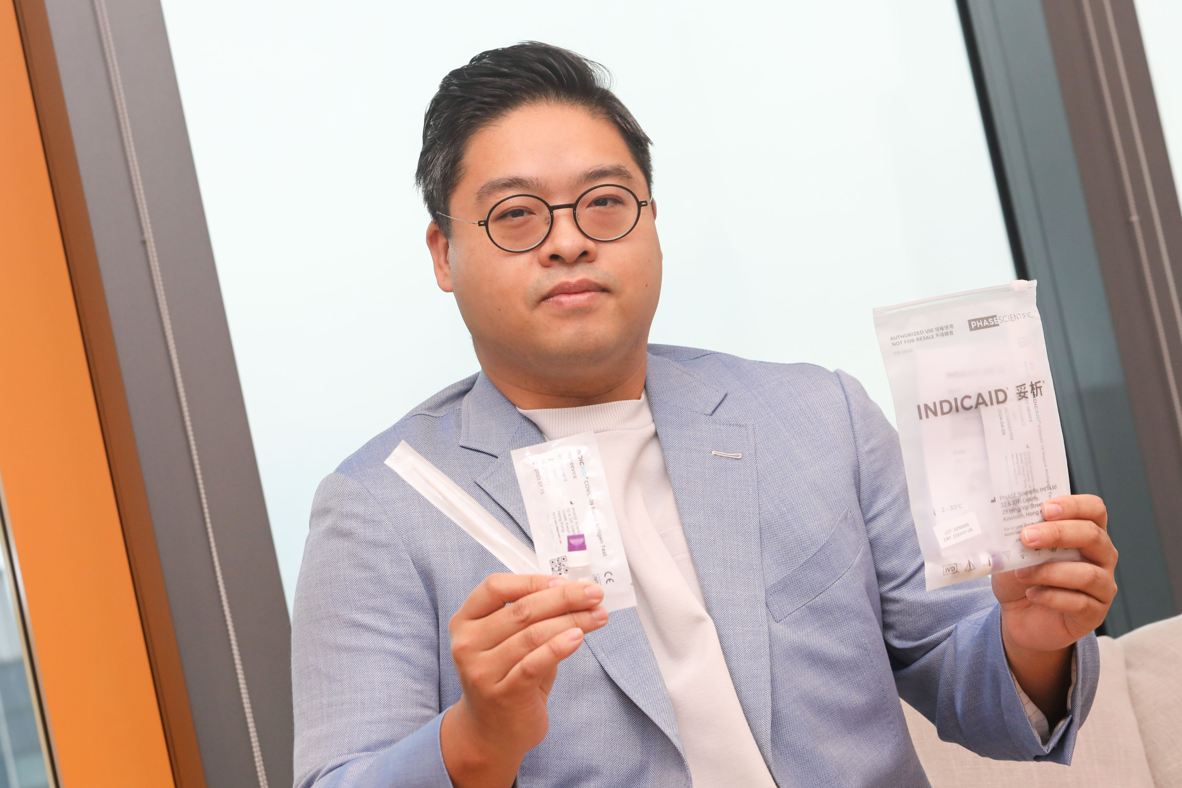 Ricky Chiu Yin-to, Chairman and CEO of Phase Scientific International, holds their rapid test kits in Kwun Tong. Photo: SCMP/Jelly Tse