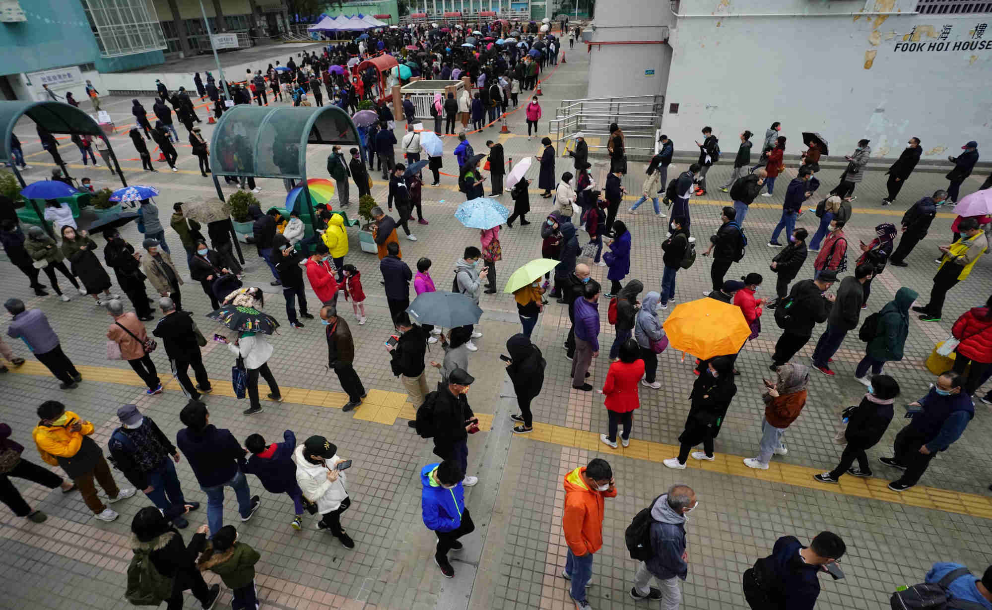 People are waiting to take Covid-19 test at a mobile test station in Hong Kong.  Photo: Felix Wong