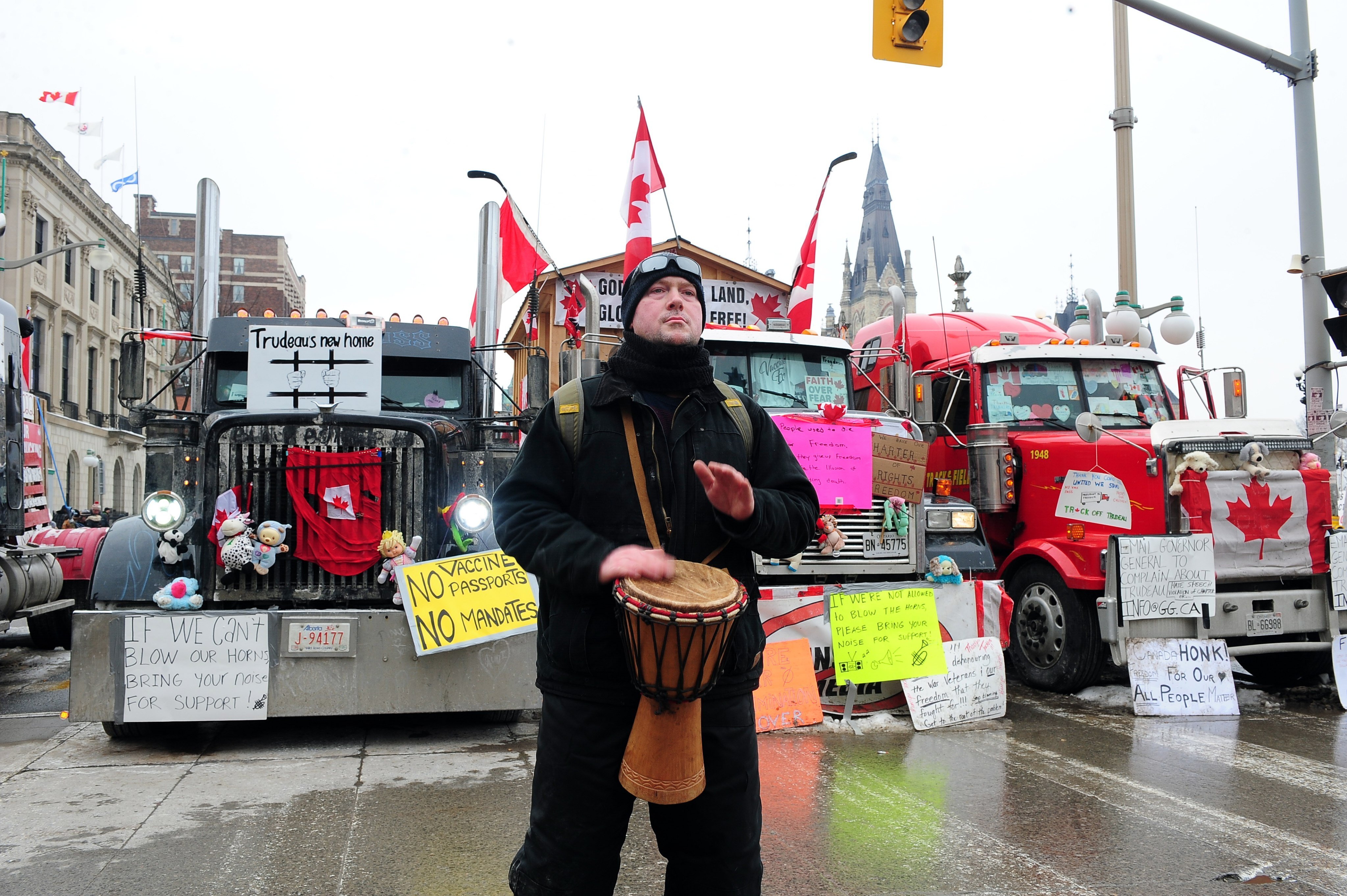 A protester beats a drum as truckers continue to protest in downtown Ottawa, Ontario, Canada. Photo: EPA