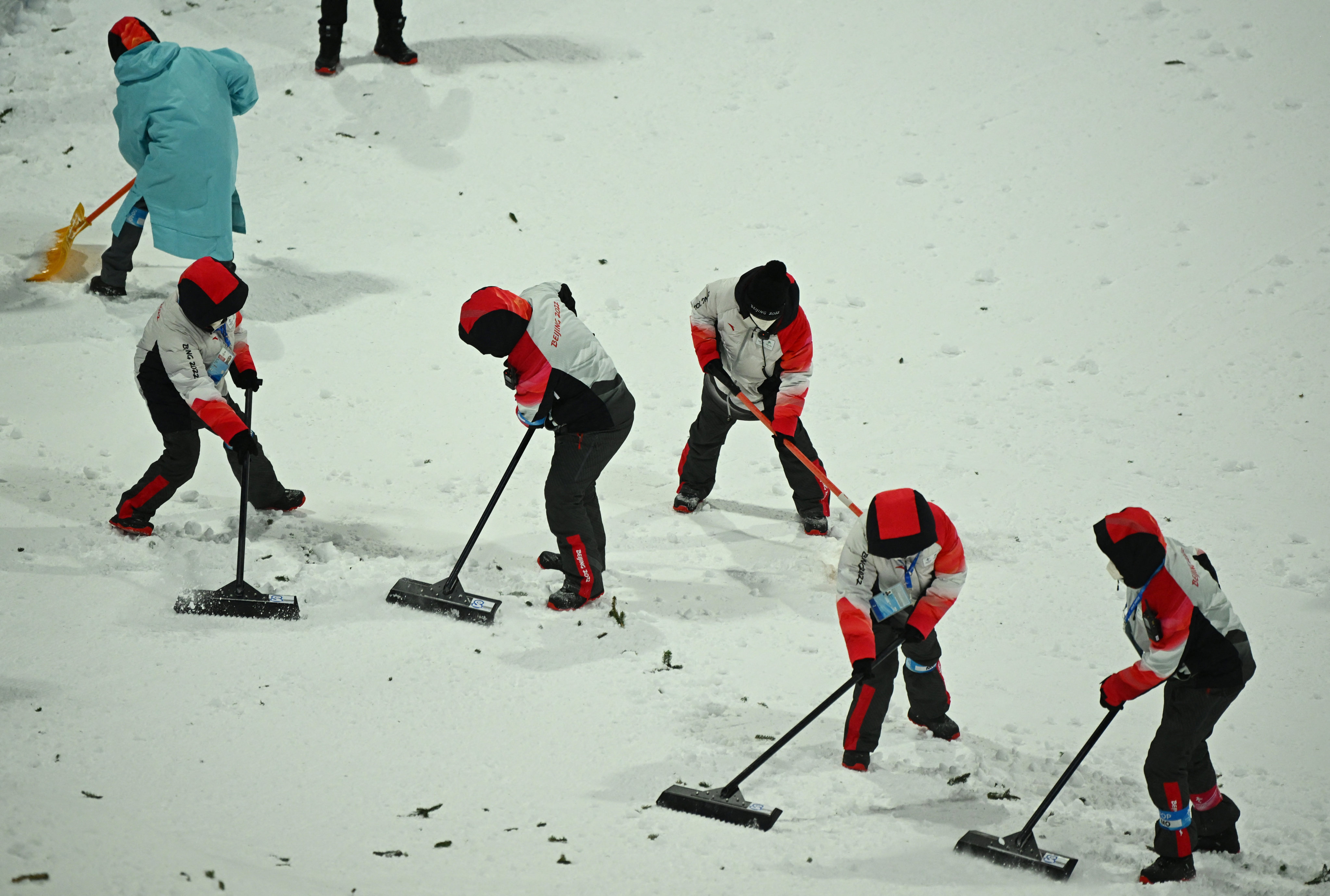 Staff work on the course during freestyle skiing training at the Genting Snow Park in Zhangjiakou, ahead of the Beijing 2022 Winter Olympics. Photo: Reuters/Dylan Martinez