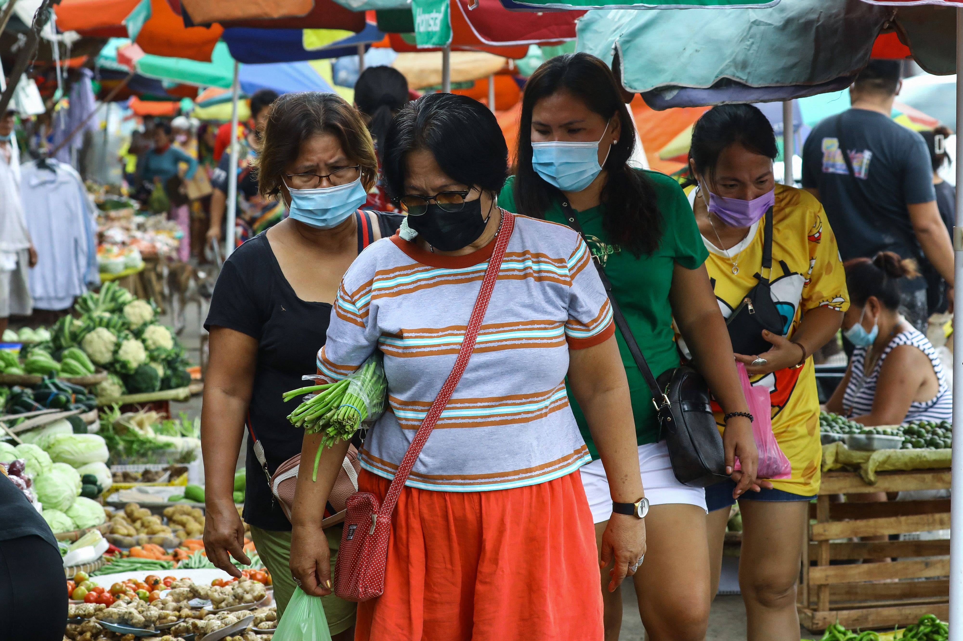 People at a market in Quezon city, Manila. Photo: AFP 