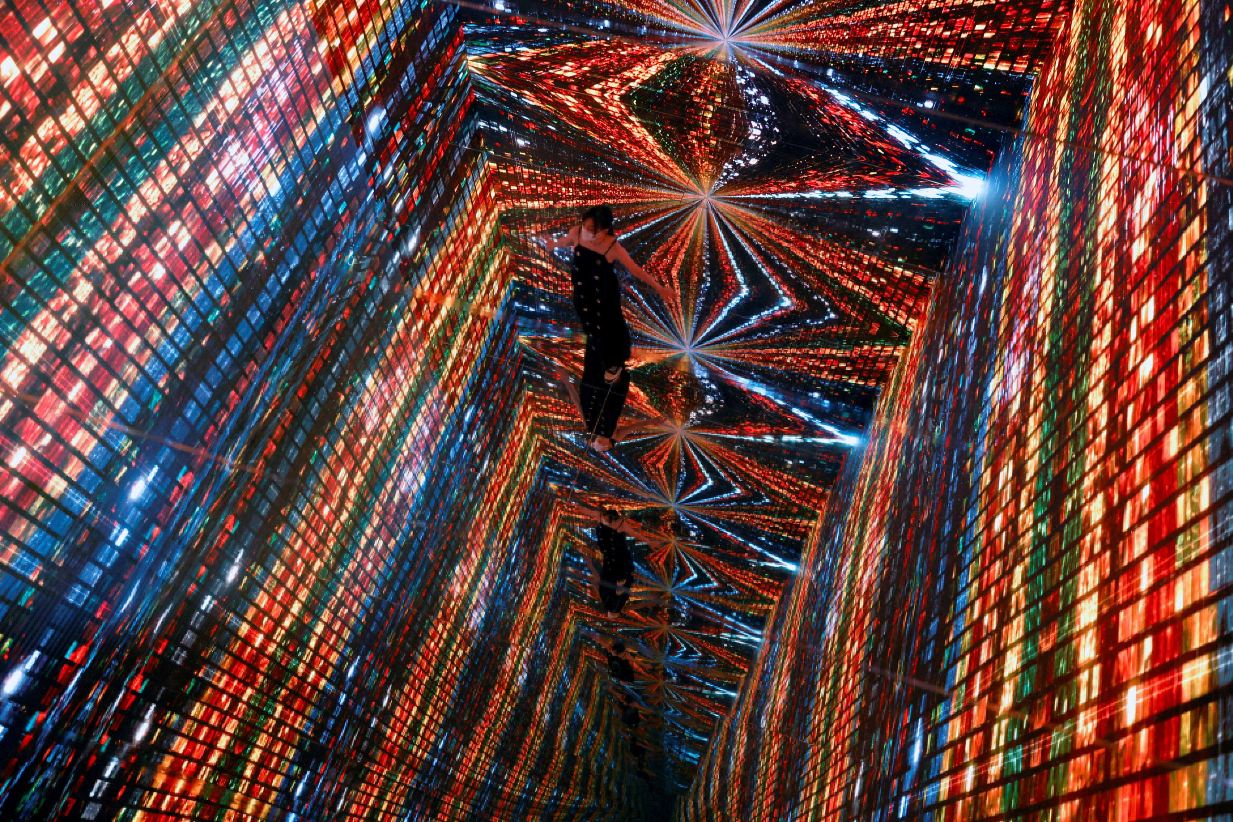 A visitor is pictured in front of an immersive art installation titled “Machine Hallucinations â Space: Metaverse” by media artist Refik Anadol, which will be converted into NFT and auctioned online at Sotheby’s, at the Digital Art Fair, in Hong Kong, China September 30, 2021. 

Photo: Reuters/Tyrone Siu