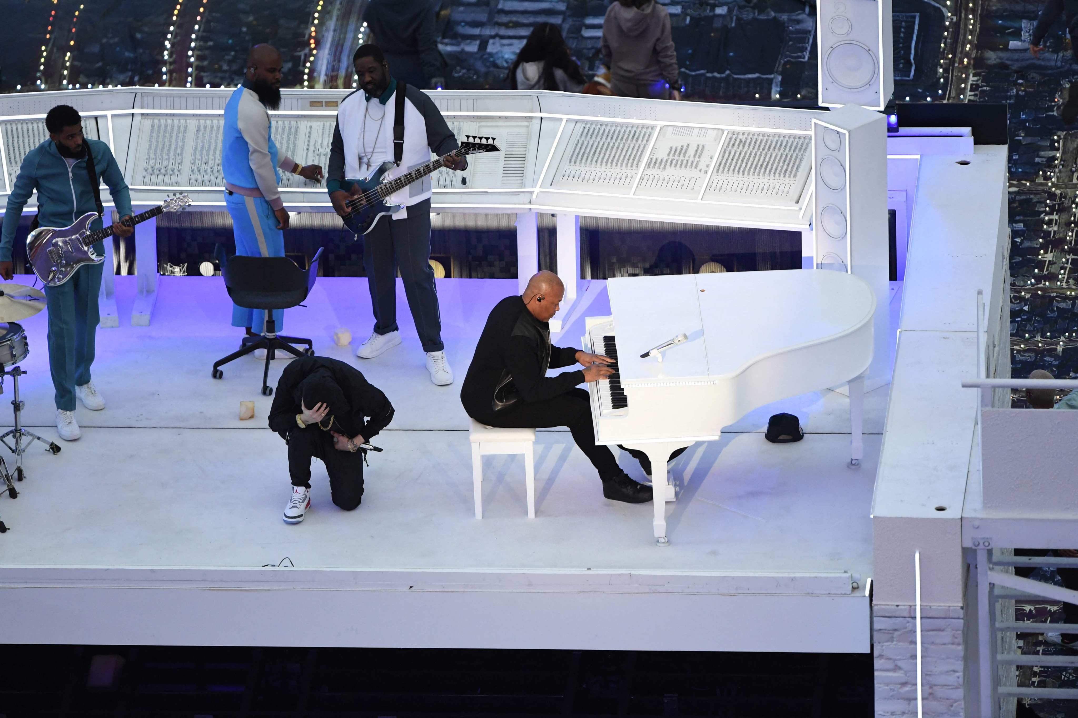 US rapper Eminem kneels on stage as he performs with Dr. Dre during the half-time show of Super Bowl LVI. Photo: AFP