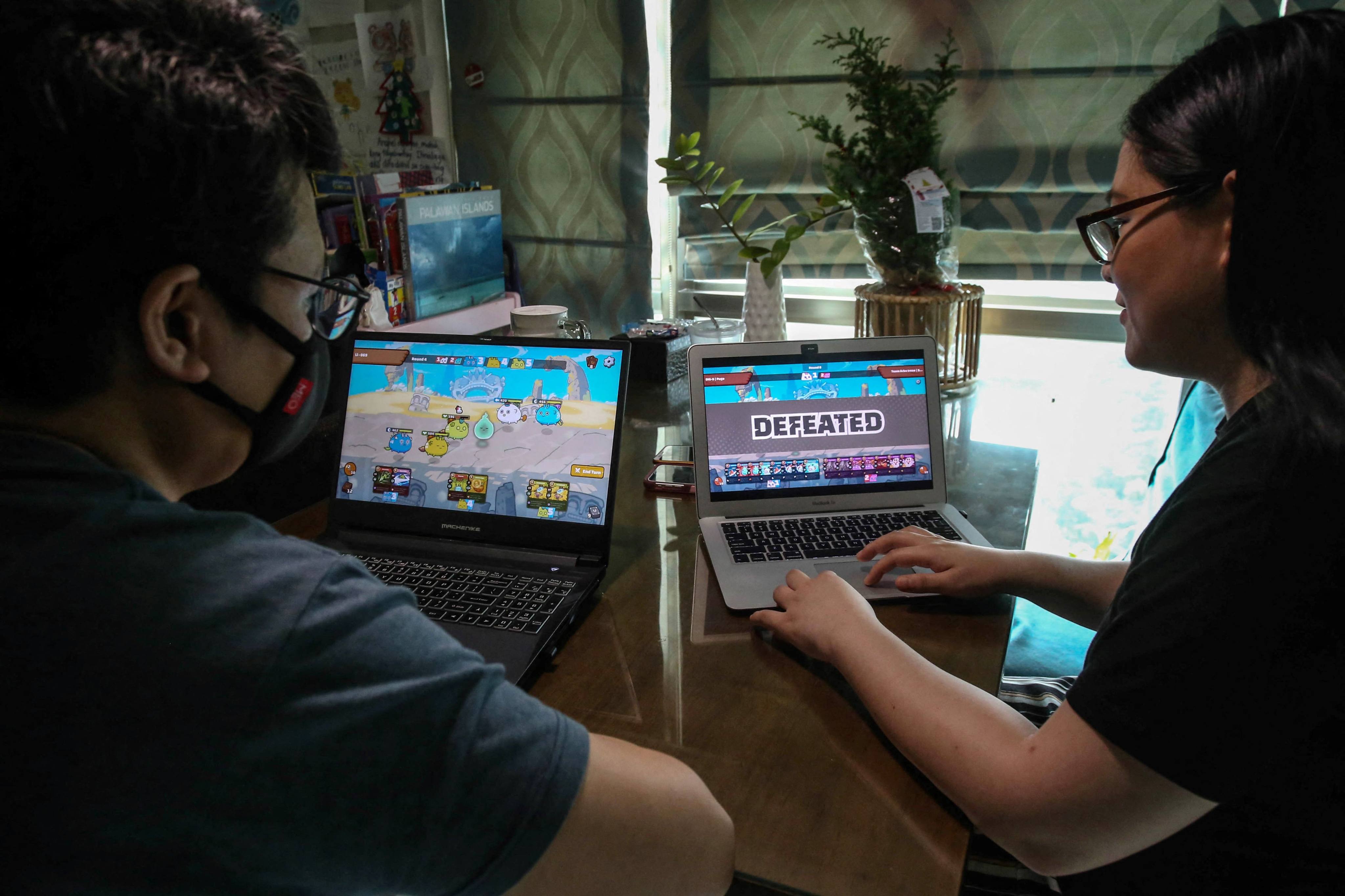 A gamer gives a demonstration on how to play Axie Infinity in Taguig, suburban Manila. Photo: AFP