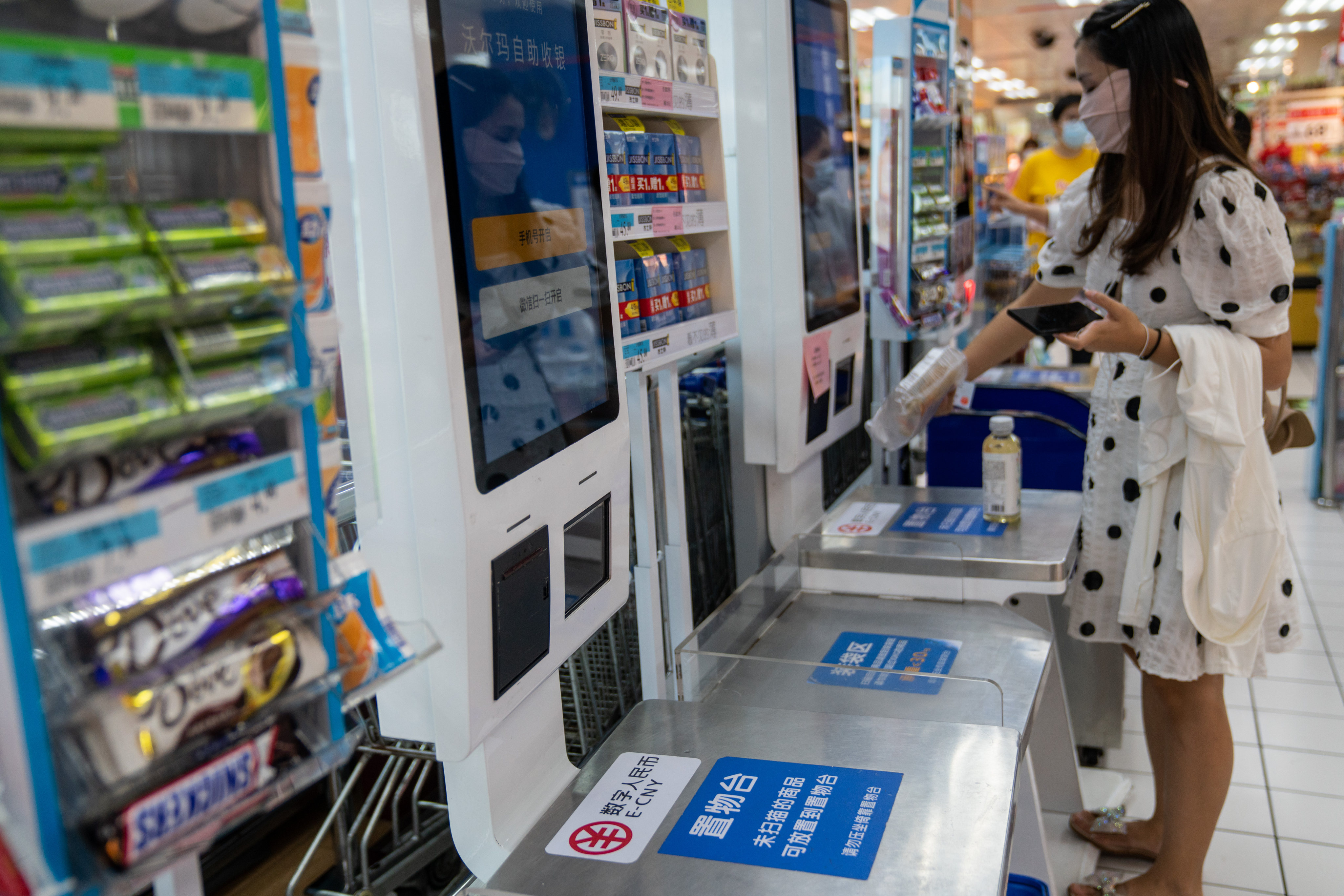 Signage for the digital yuan, or e-CNY, at a self check-out counter inside a supermarket in Shenzhen. Rather than replace existing digital payment platforms, as predicted by some, China’s digital yuan will complement and work alongside them. Photo: Bloomberg