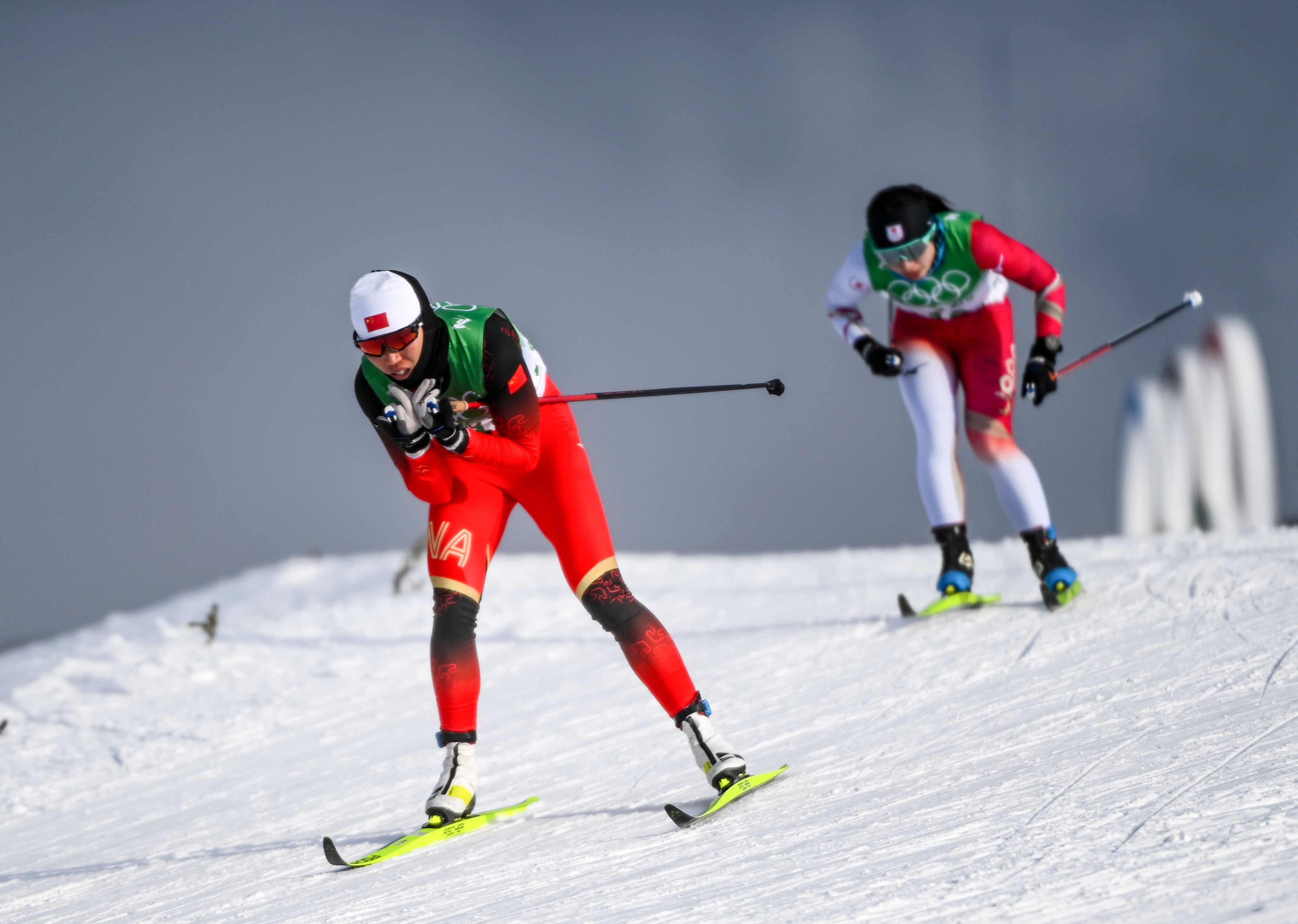 Li Xin (left) of China in the cross-country skiing women’s relay qualifying event at the Beijing Winter Olympic Games at the National Cross-Country Skiing Centre in Zhangjiakou. Photo: Xinhua  