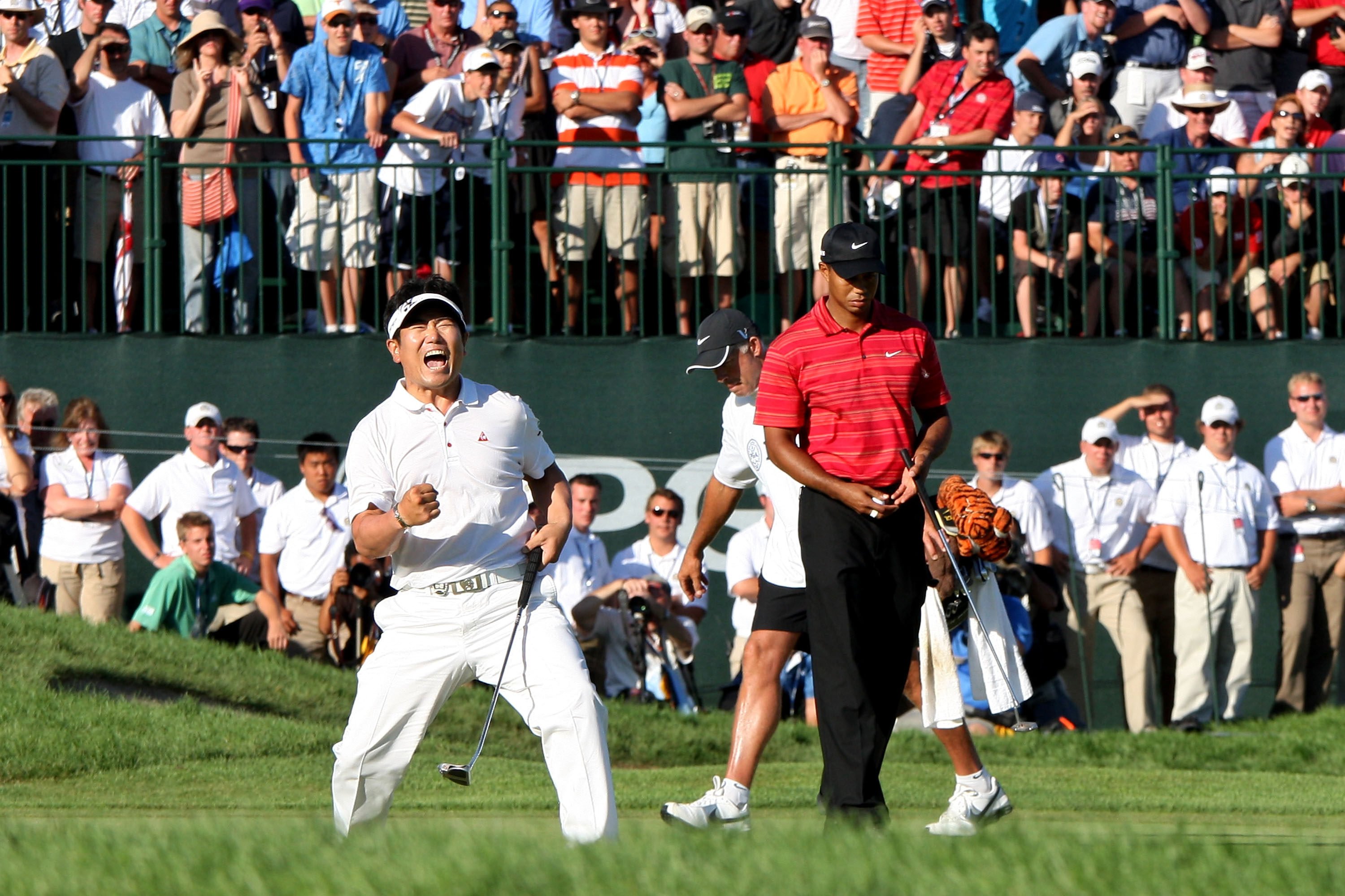 Y.E. Yang celebrates a birdie putt on the 18th green alongside Tiger Woods during the final round of the 91st PGA Championship at Hazeltine National Golf Club on August 16, 2009. Photo: Getty Images