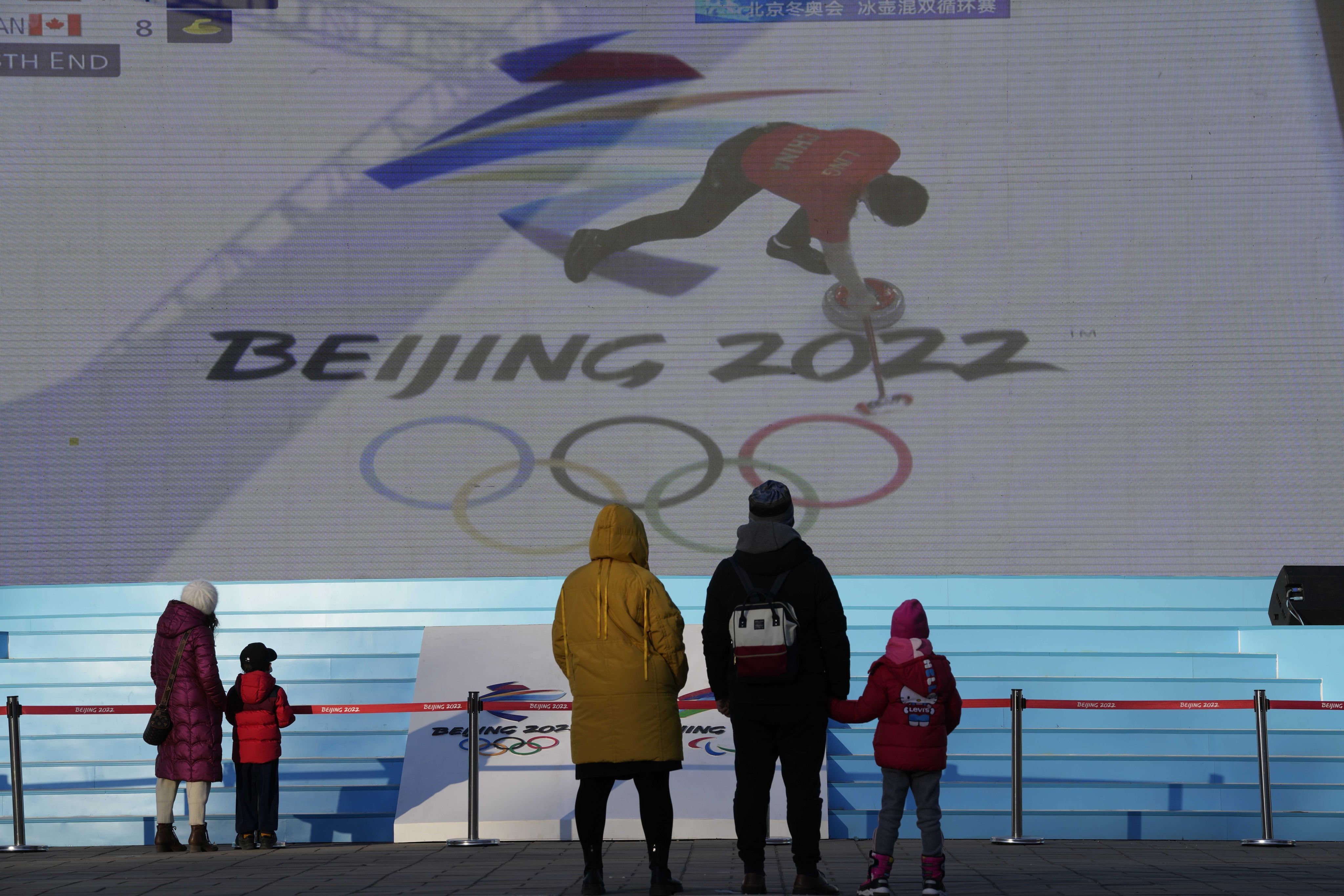 People watch a broadcast of a curling competition, shown on a big screen, during the Beijing 2022 Winter Olympics on February 5, 2022. Photo: AP