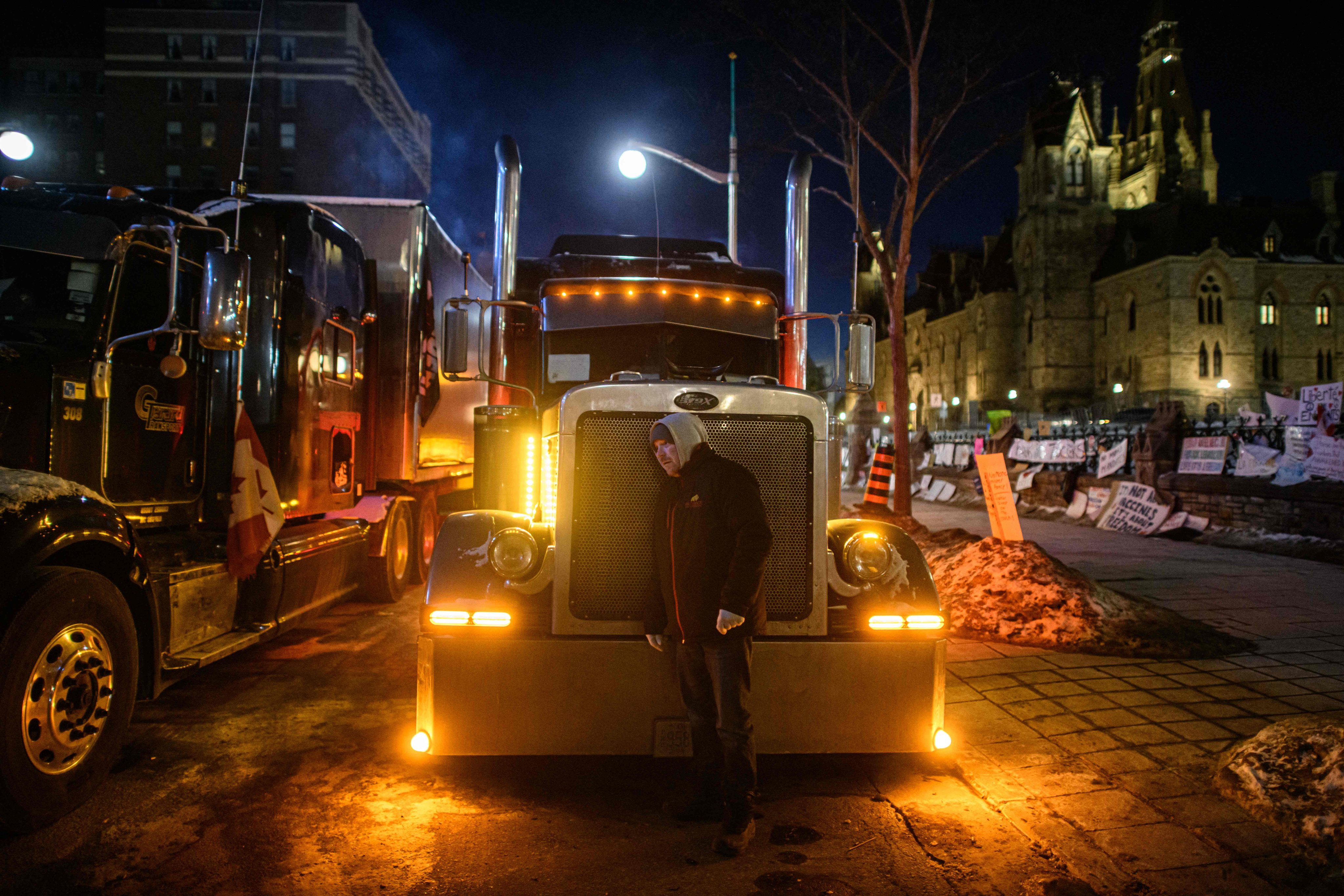 A truck driver listens to his vehicle’s engine during a protest over pandemic health rules outside the parliament of Canada in Ottawa on Monday. Photo: AFP