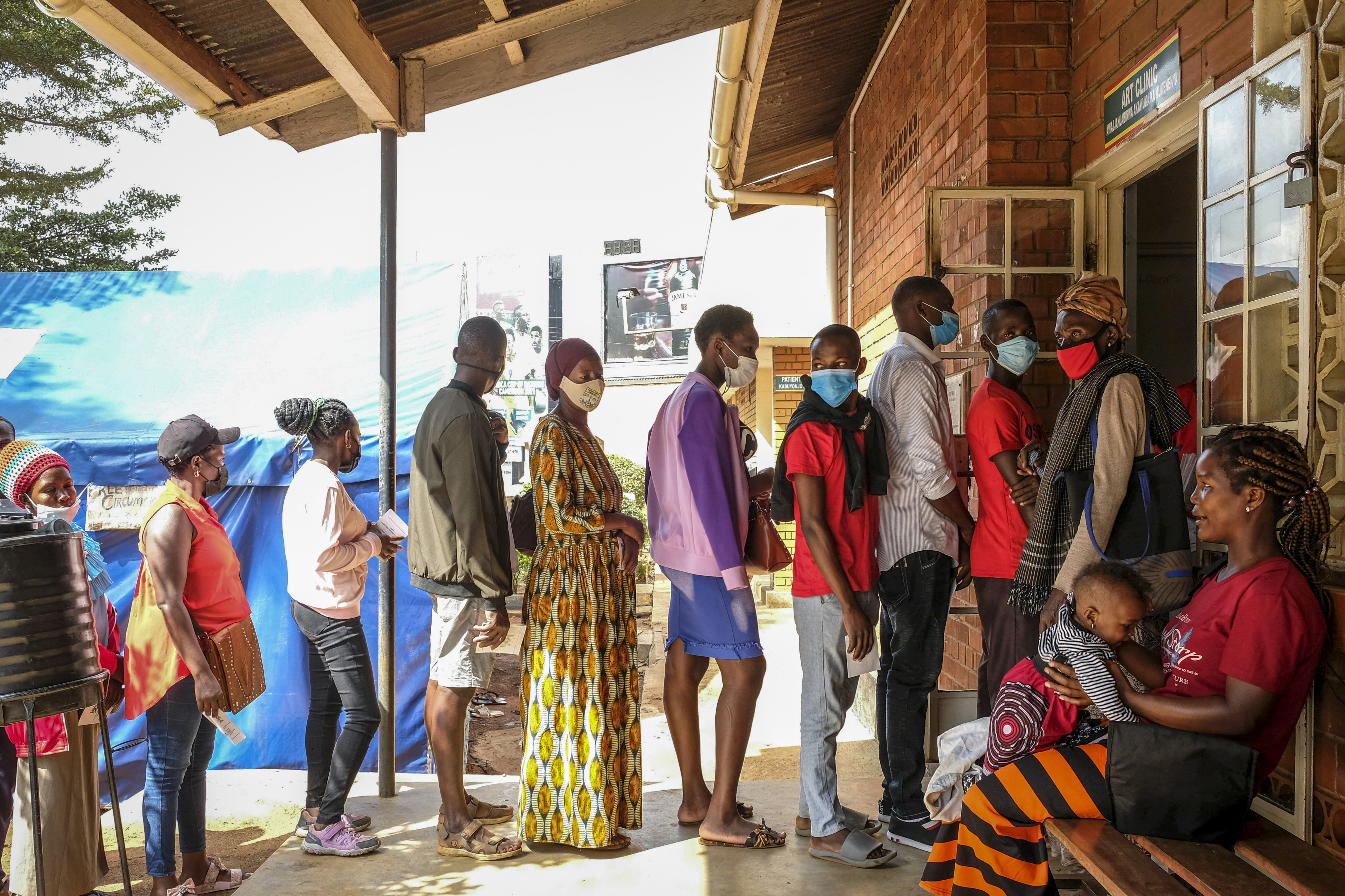 Ugandans queue to receive Pfizer coronavirus vaccines at the Kiswa Health Centre III in the Bugolobi neighborhood of Kampala, Uganda, on February 8. As long as Covid-19 is still spreading somewhere in the world, then it has the chance to mutate. Photo: AP 