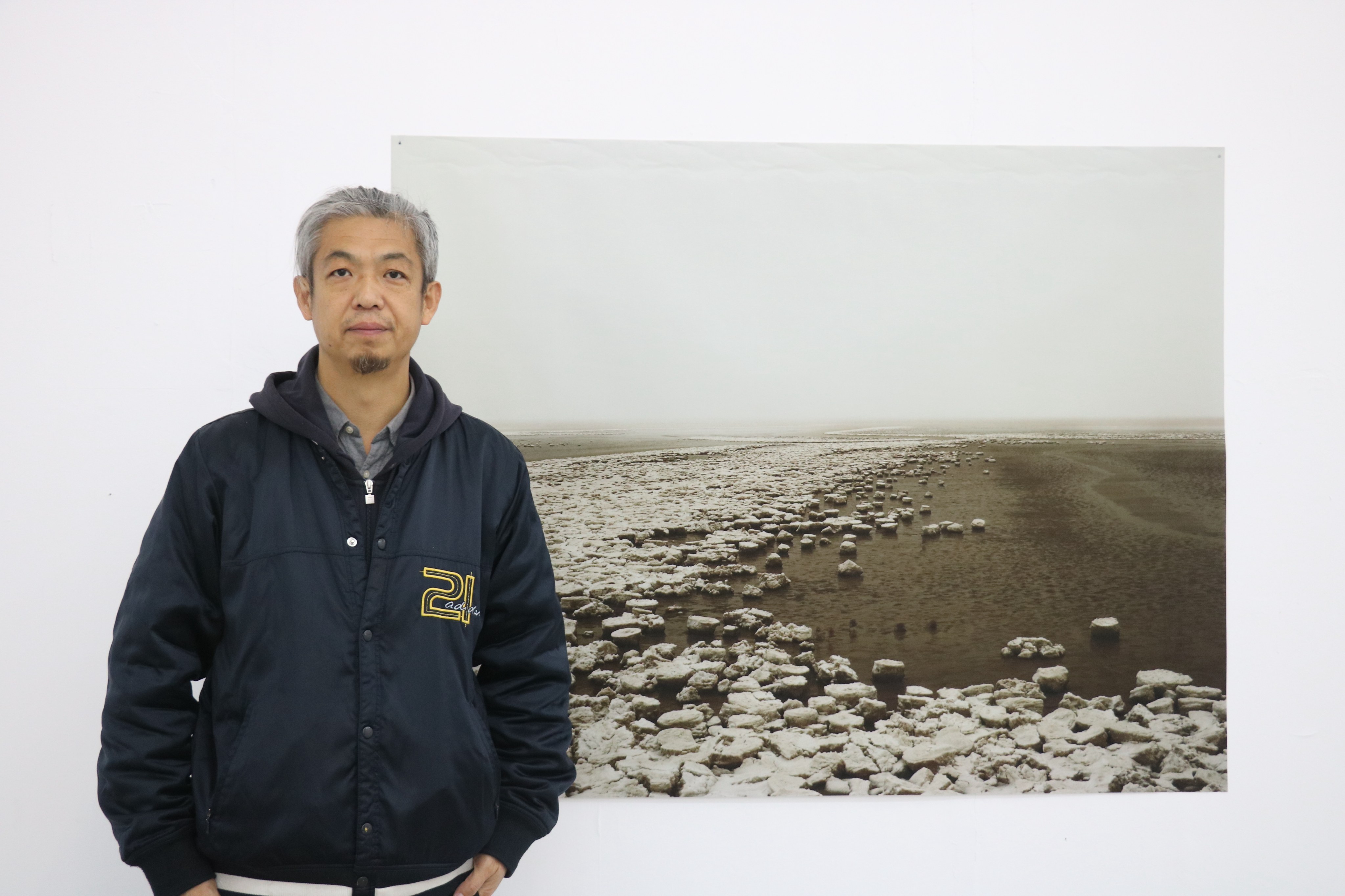 Li Lin photographed at his exhibition at Lianzhou Foto in 2019. Raised on an experimental farm near the mouth of the Yellow River, his recent work documents the area as it has changed in the 21st century. Photo: Thomas Bird