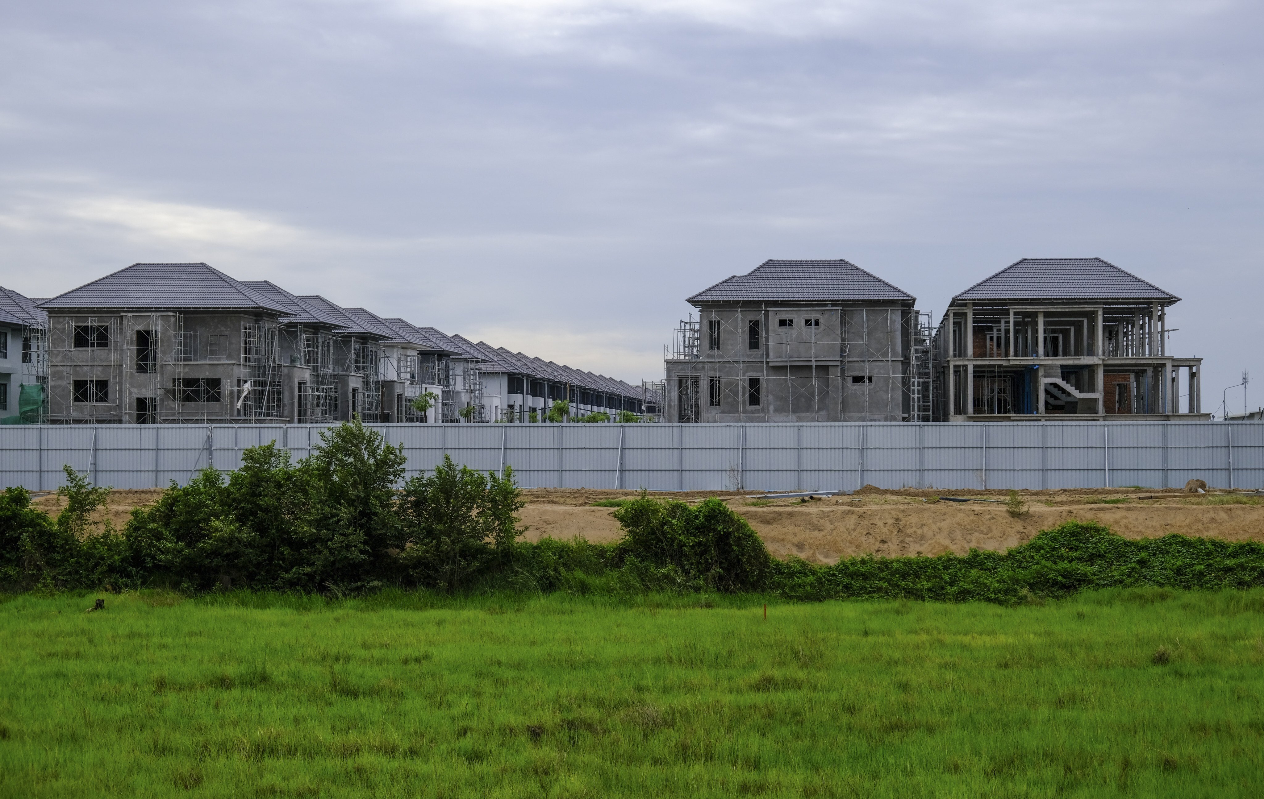 Newly built houses sit on top of a buried  archeological site at Srok Chek near Phnom Penh in Cambodia. Ancient sites across the country are under threat from developers, in contrast to temoles at Angkor and elsewhere that have been preserved. Photo: Peter Ford