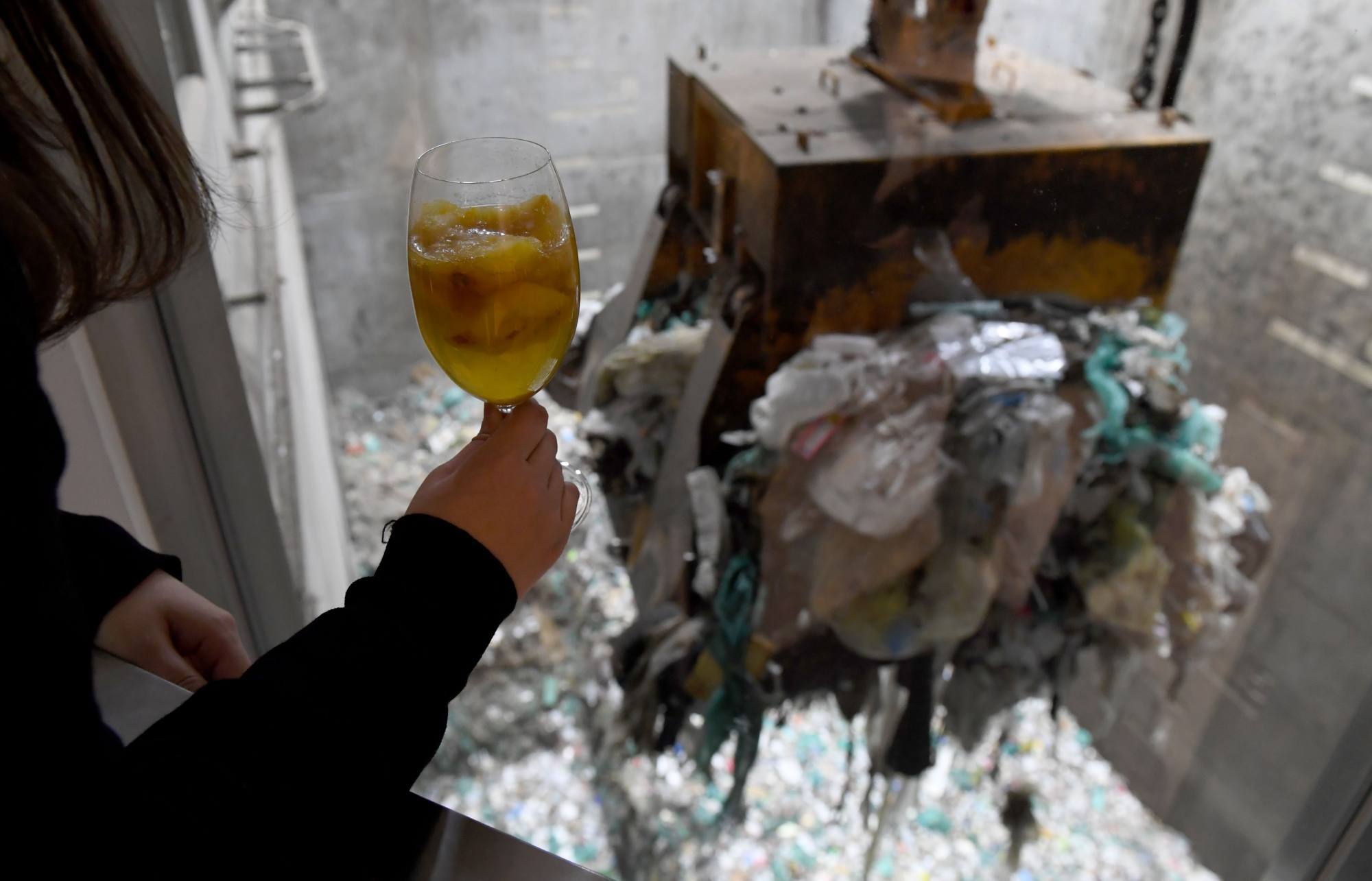 A crane picks up rubbish for incineration at a combustible waste pit at the “Gomi Pit” bar in Tokyo in 2019. Photo: AFP