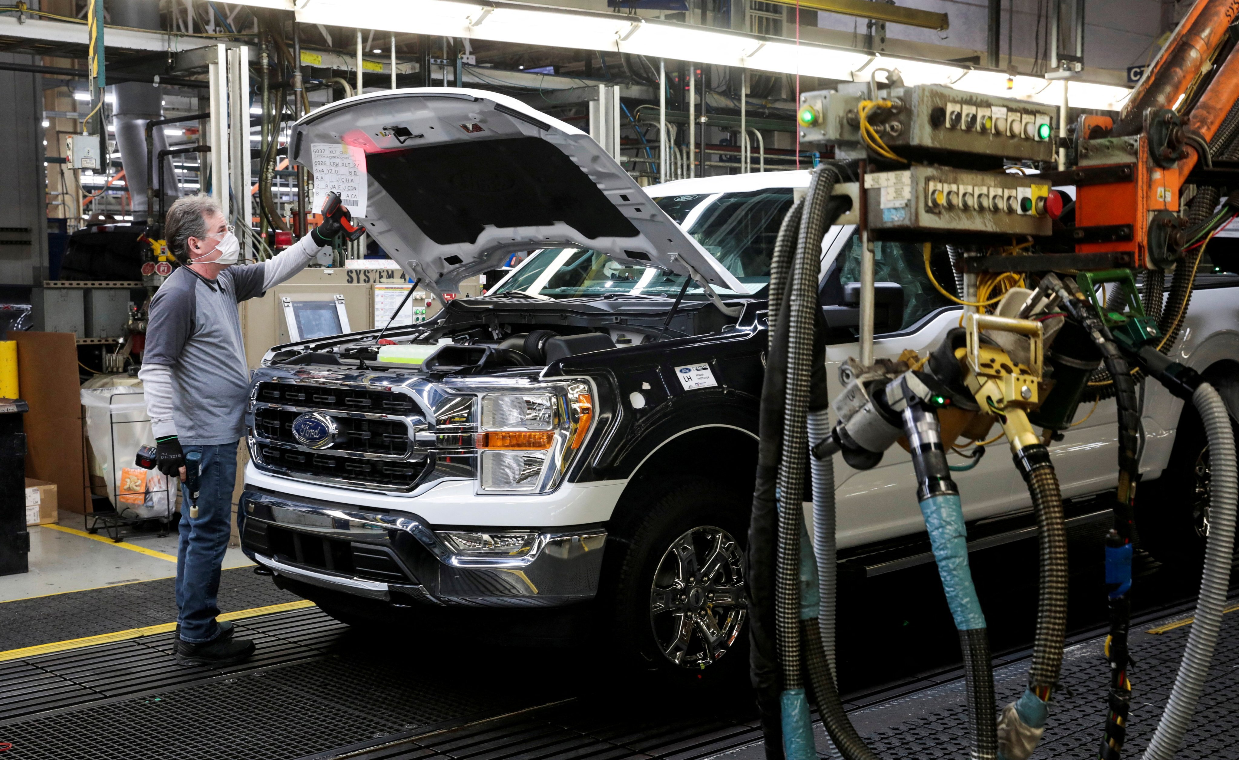An assembly worker of Ford Motor works on an F-series pickup truck at the Dearborn Truck Plant in Dearborn, Michigan on January 26, 2022. Photo: Reuters 