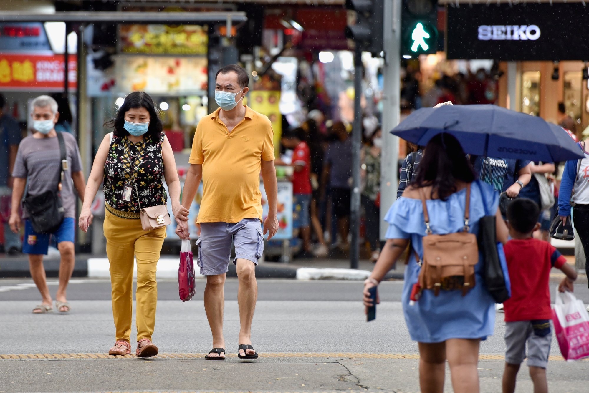 People cross a road during the coronavirus pandemic in Singapore in November 2021. Photo: Reuters