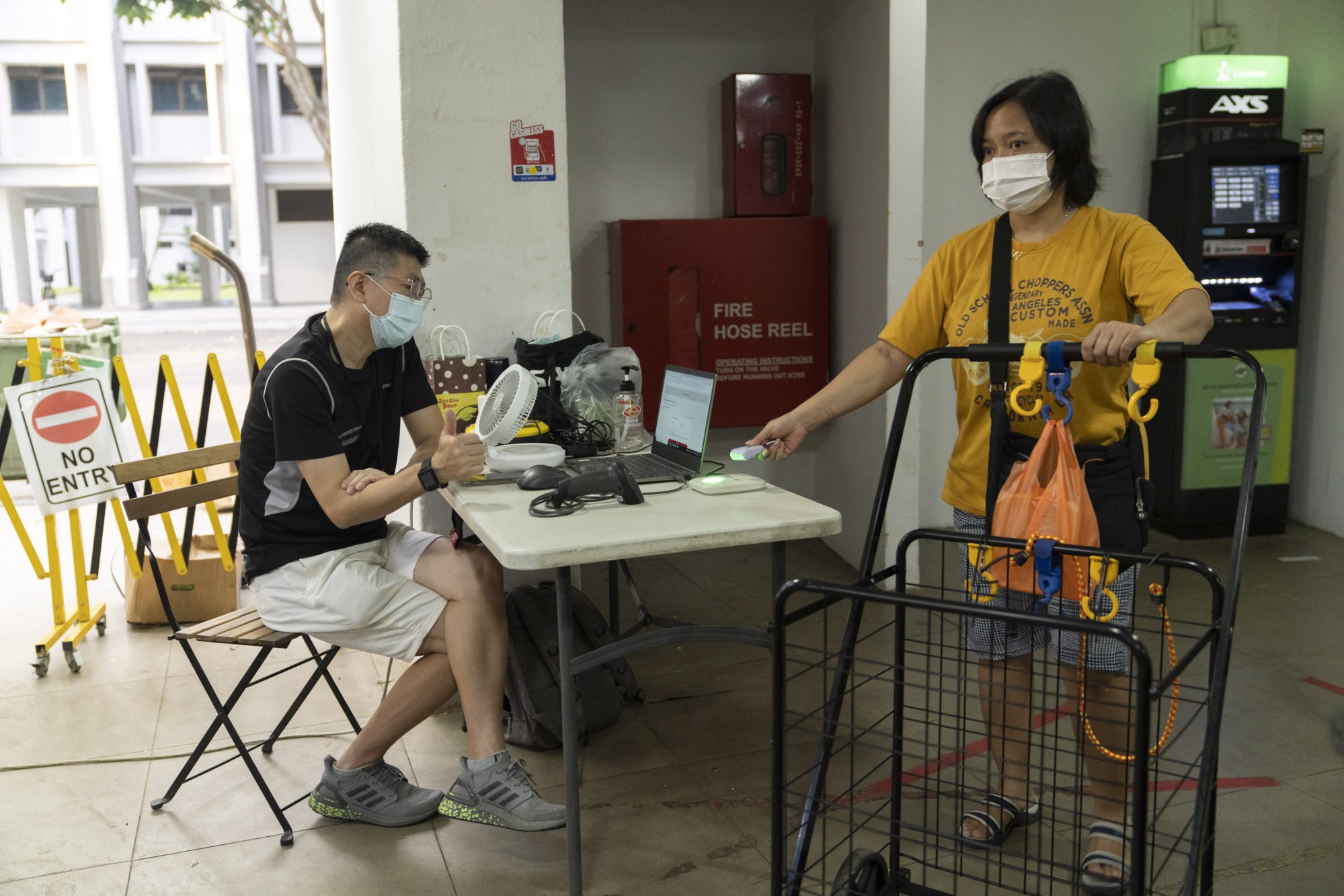 A visitor checks in with the Trace Together contact-tracing token for Safe Entry while entering a wet market in Singapore in December 2021. Photo: Bloomberg
