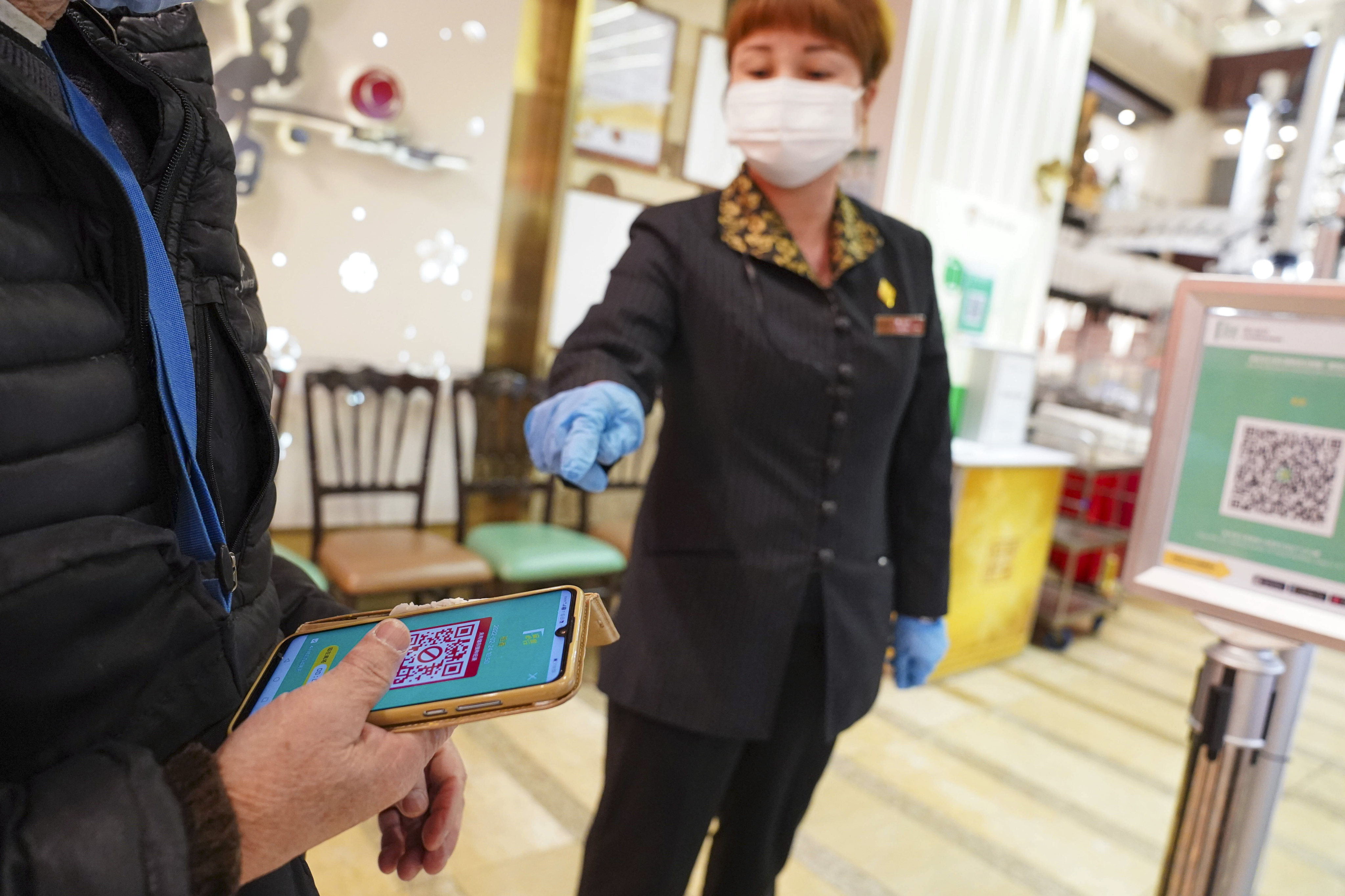 A person uses the “Leave Home Safe” app to enter a restaurant in Tsing Yi on Thursday morning. Photo: Sam Tsang