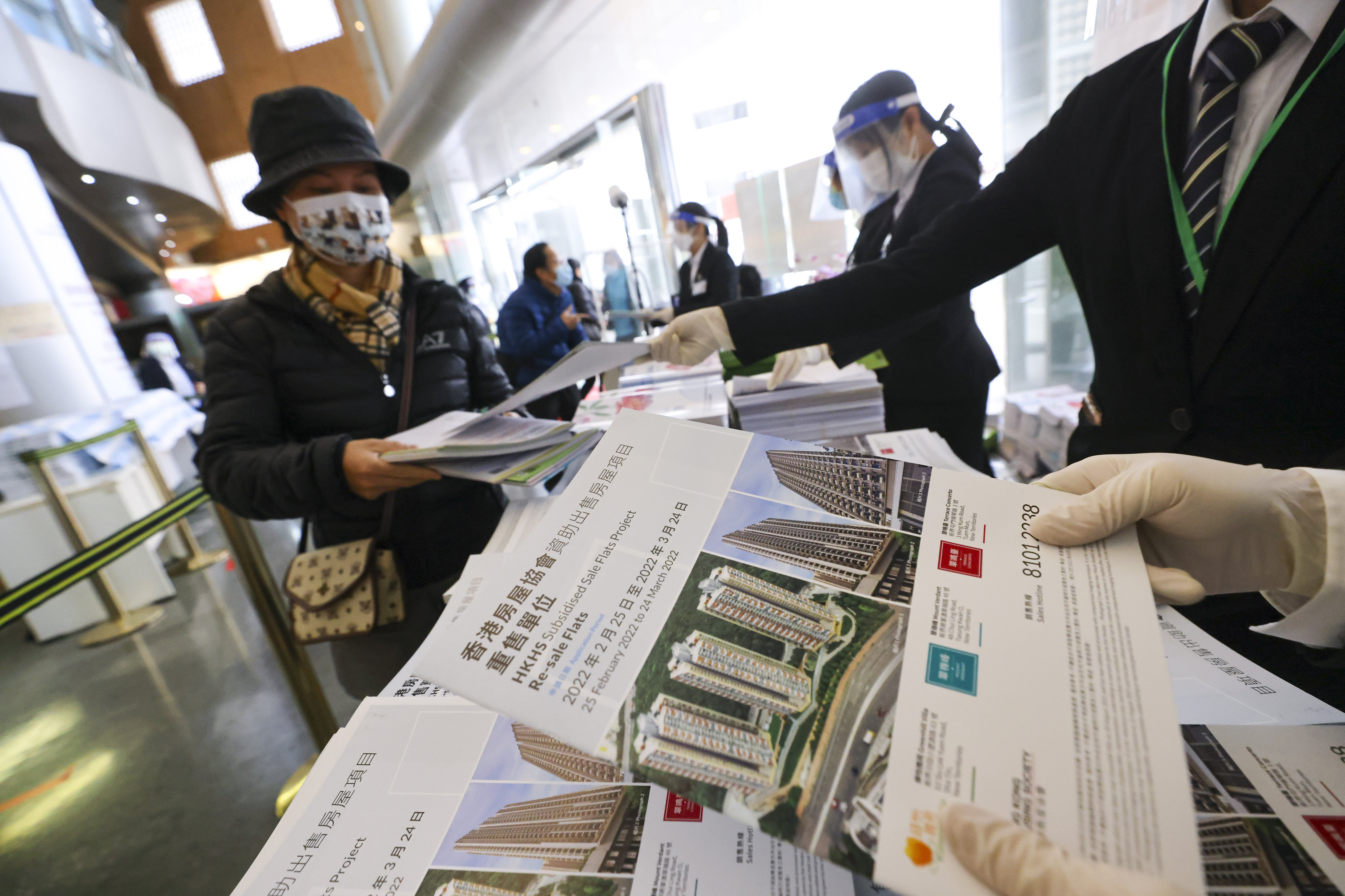 Residents take application forms for a chance to buy a flat in this year’s Home Ownership Scheme. Photo: Dickson Lee