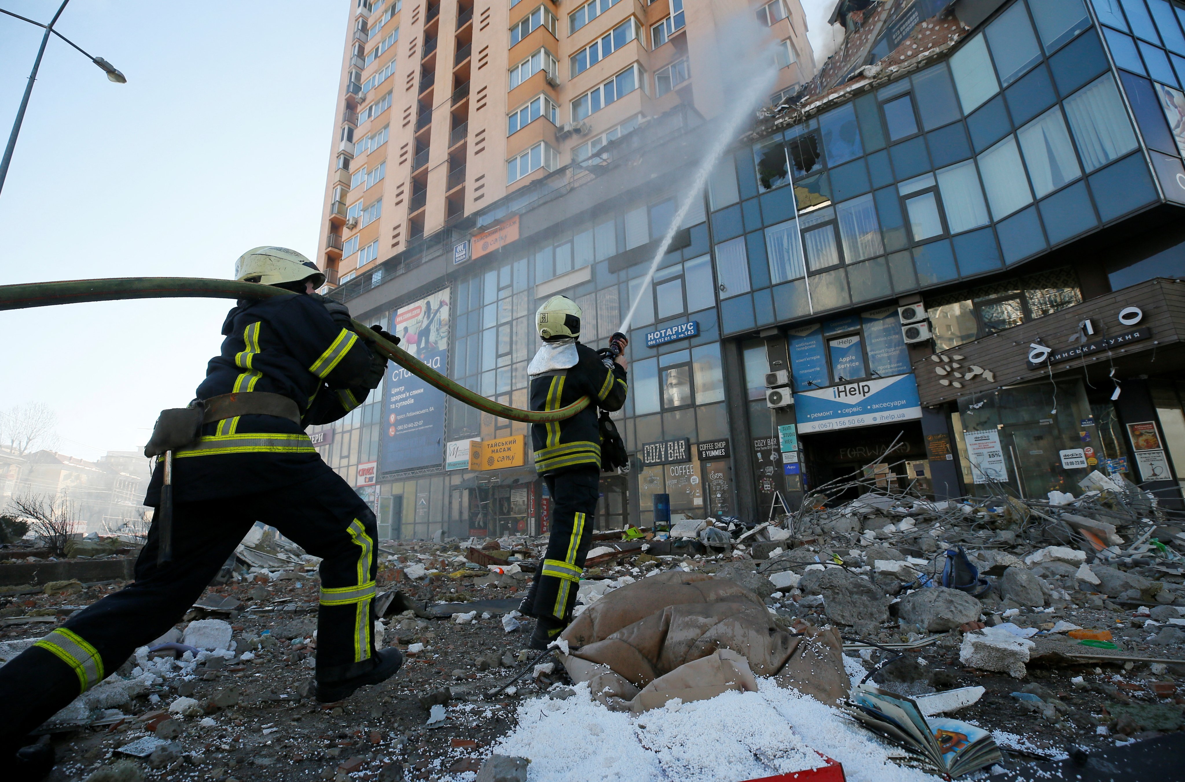 Firefighters tackle a blaze in a residential building damaged by shelling in Kyiv, Ukraine, on Saturday. Photo: Reuters