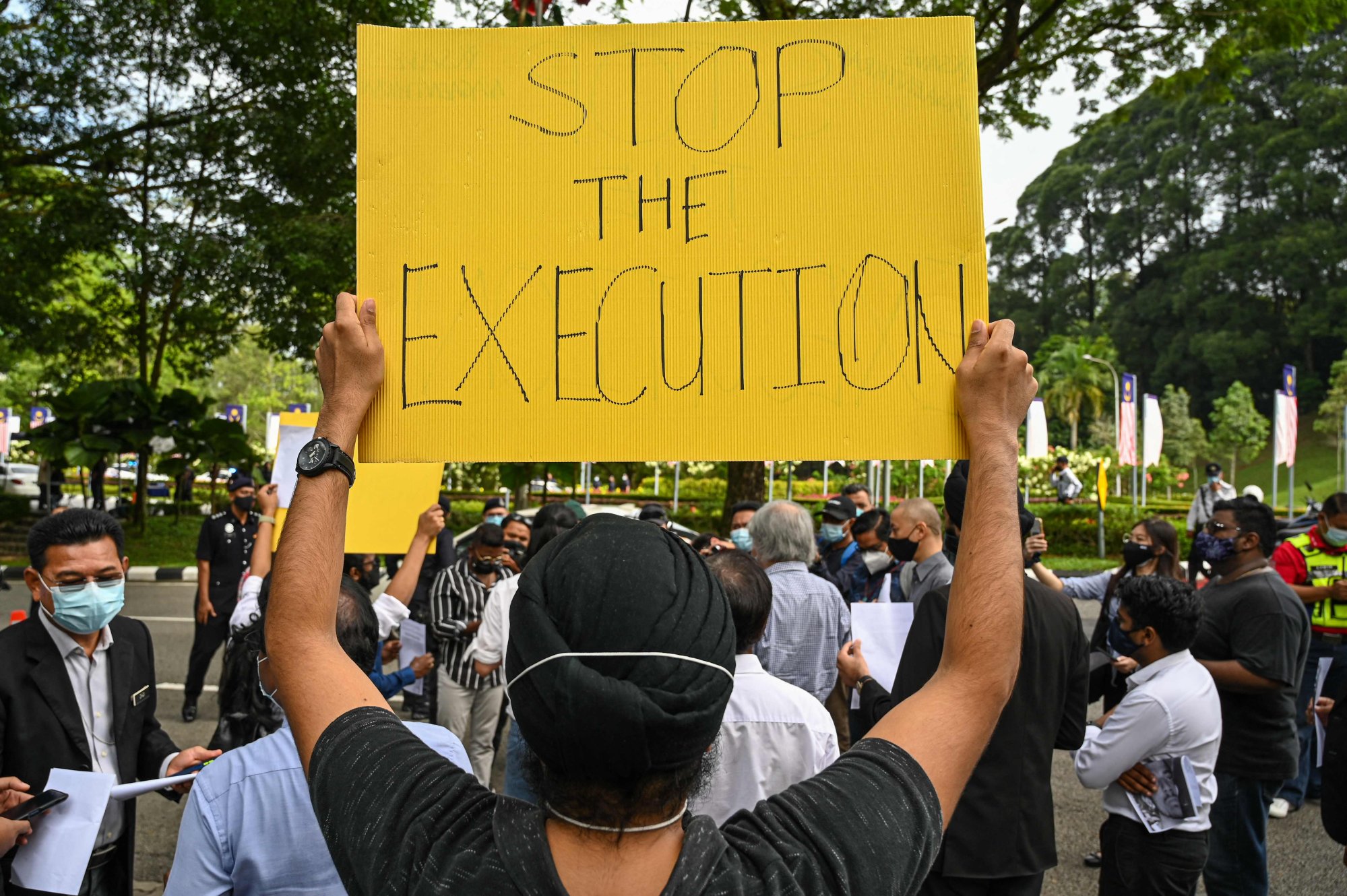 An activist in Malaysia holds a placard in 2021 to protest at the death sentence given to Nagaenthran K. Dharmalingam for trafficking heroin into Singapore. Photo: AFP