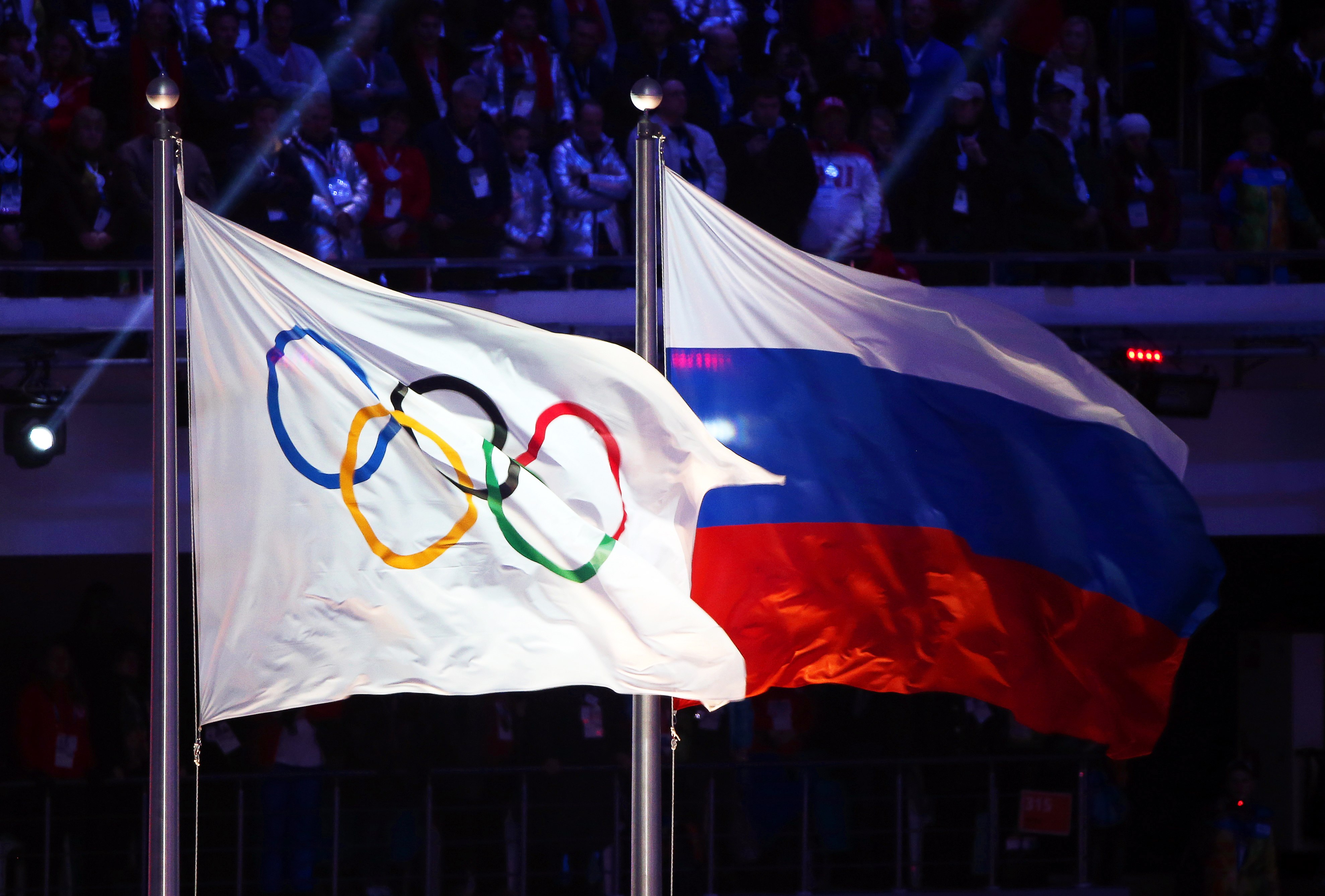 The Olympic flag (left) and Russian flag on display during the closing ceremony of the Sochi 2014 Olympic Games. Photo: EPA-EFE