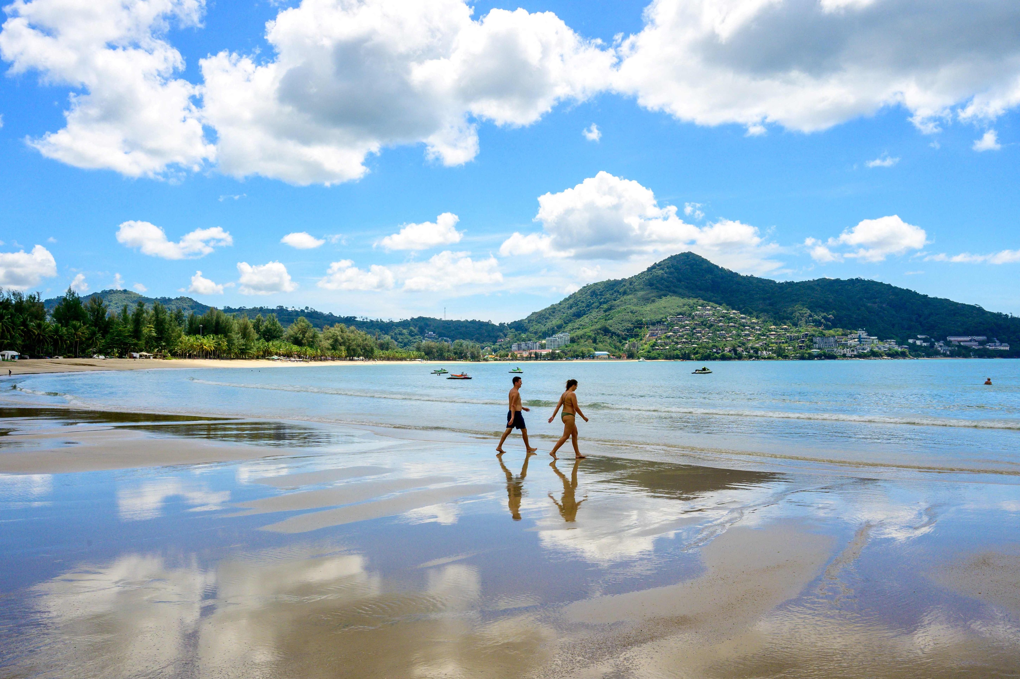 Tourists walk on a beach on the Thai island of Phuket last year. Photo: AFP