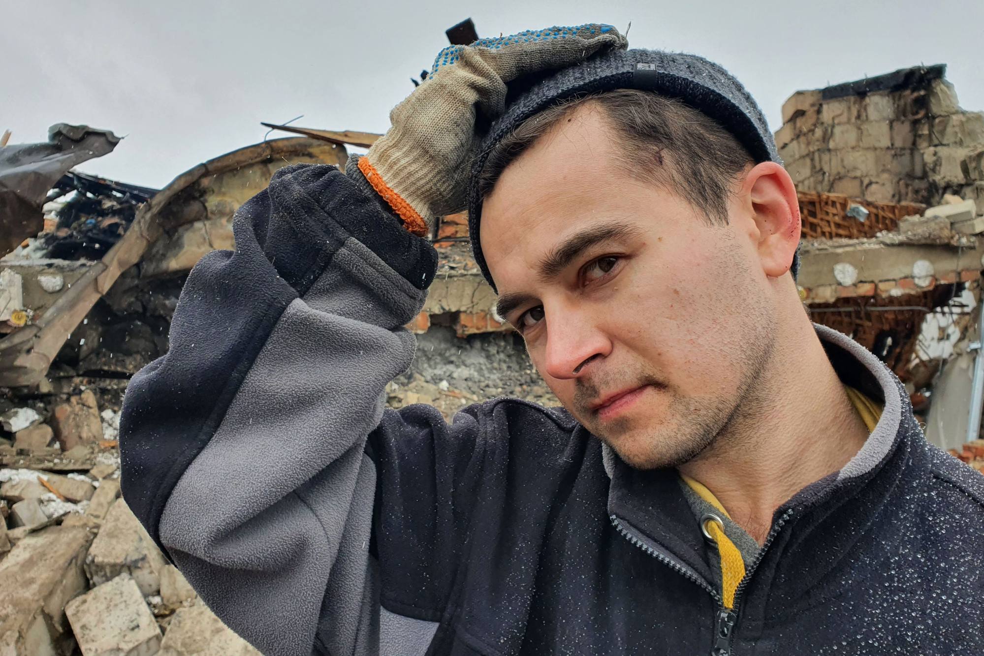 Oleg Rubak, 32, whose wife Katia, 29, has died in Russian shelling, in the rubble of his house in Zhytomyr, western Ukraine, on Wednesday. The shelling on Tuesday killed at least three and injured nearly 20, according to local authorities. Photo: AFP