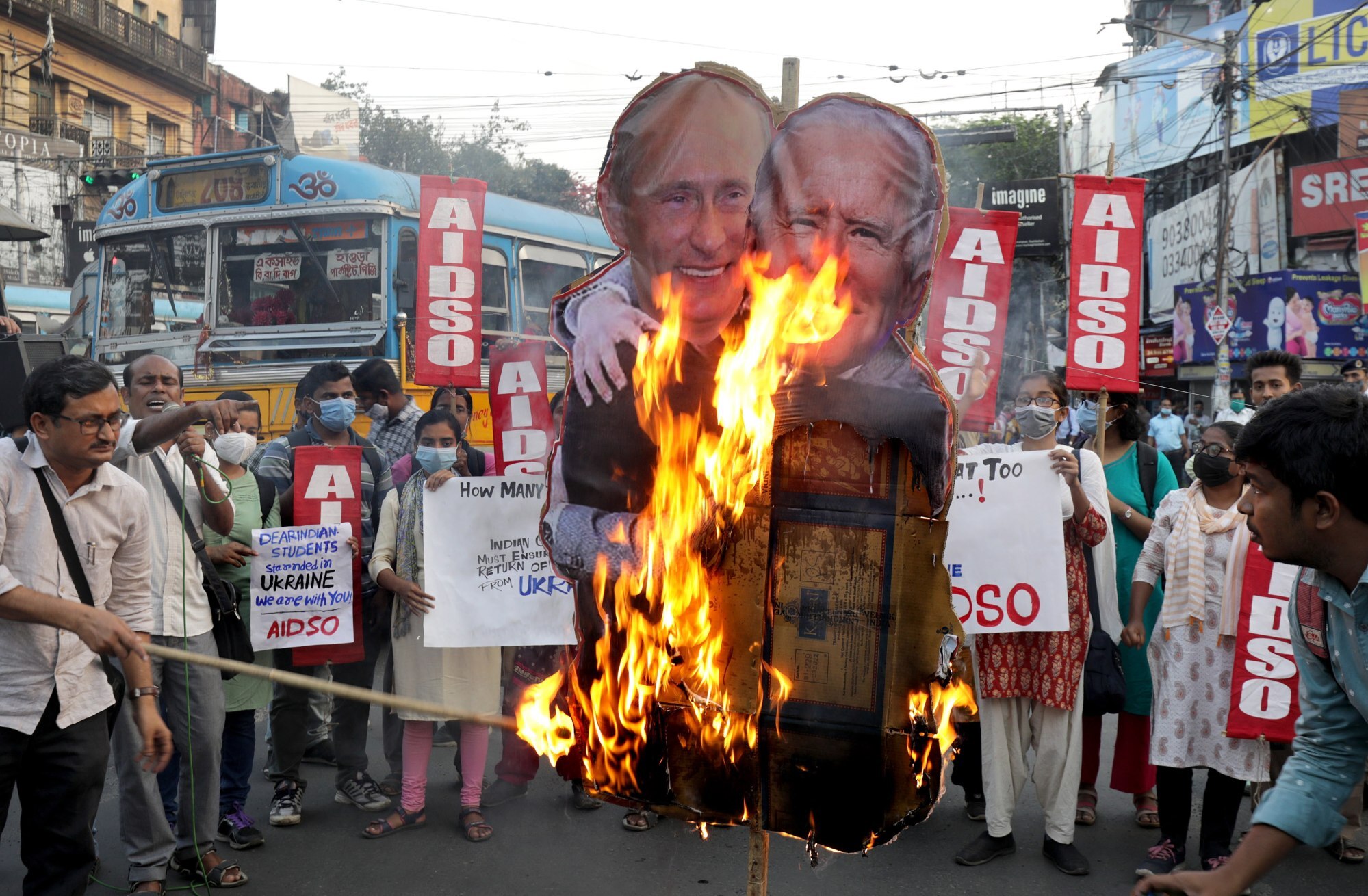 Activists of the All India Democratic Students Organisation burn a picture of Russian president Vladimir Putin (L) and US President Joe Biden. Photo: EPA-EFE