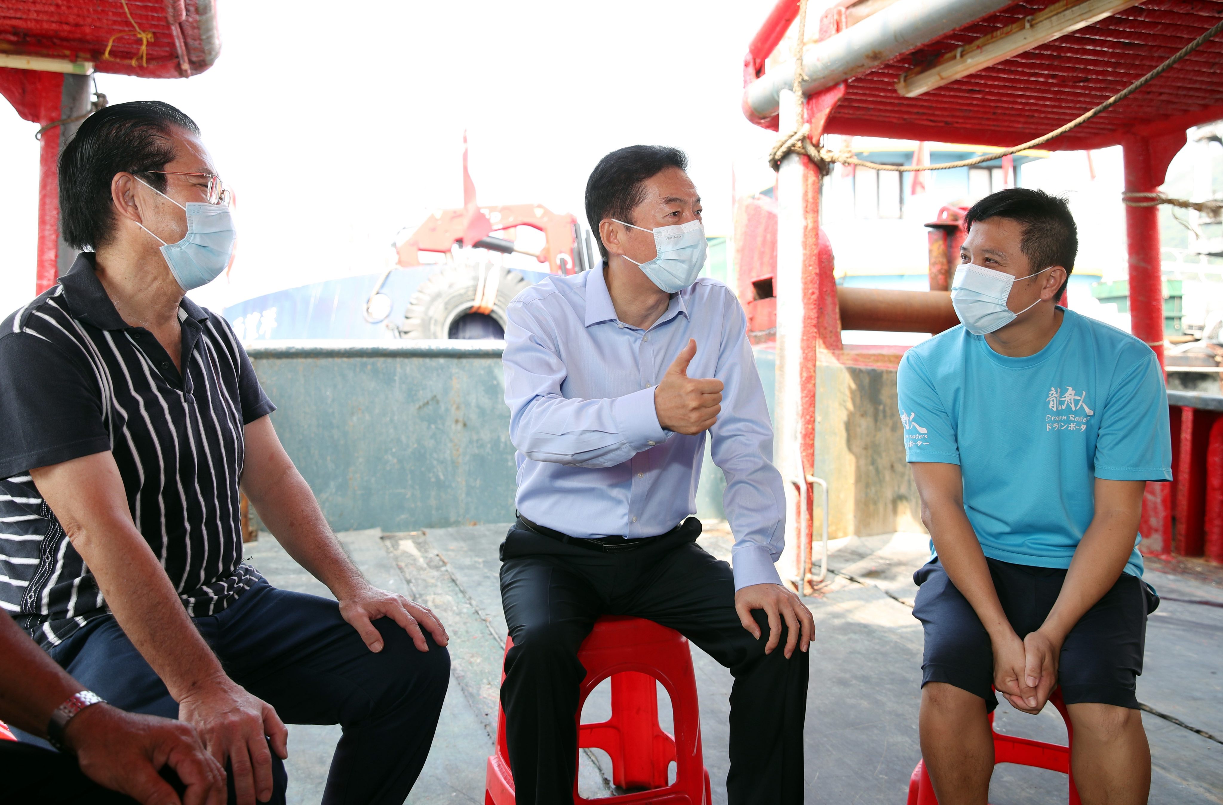 Luo Huining (centre), the director of Beijing’s liaison office, visits fishermen in Aberdeen on September 30, 2021, as part of a listening tour. Photo: Handout
