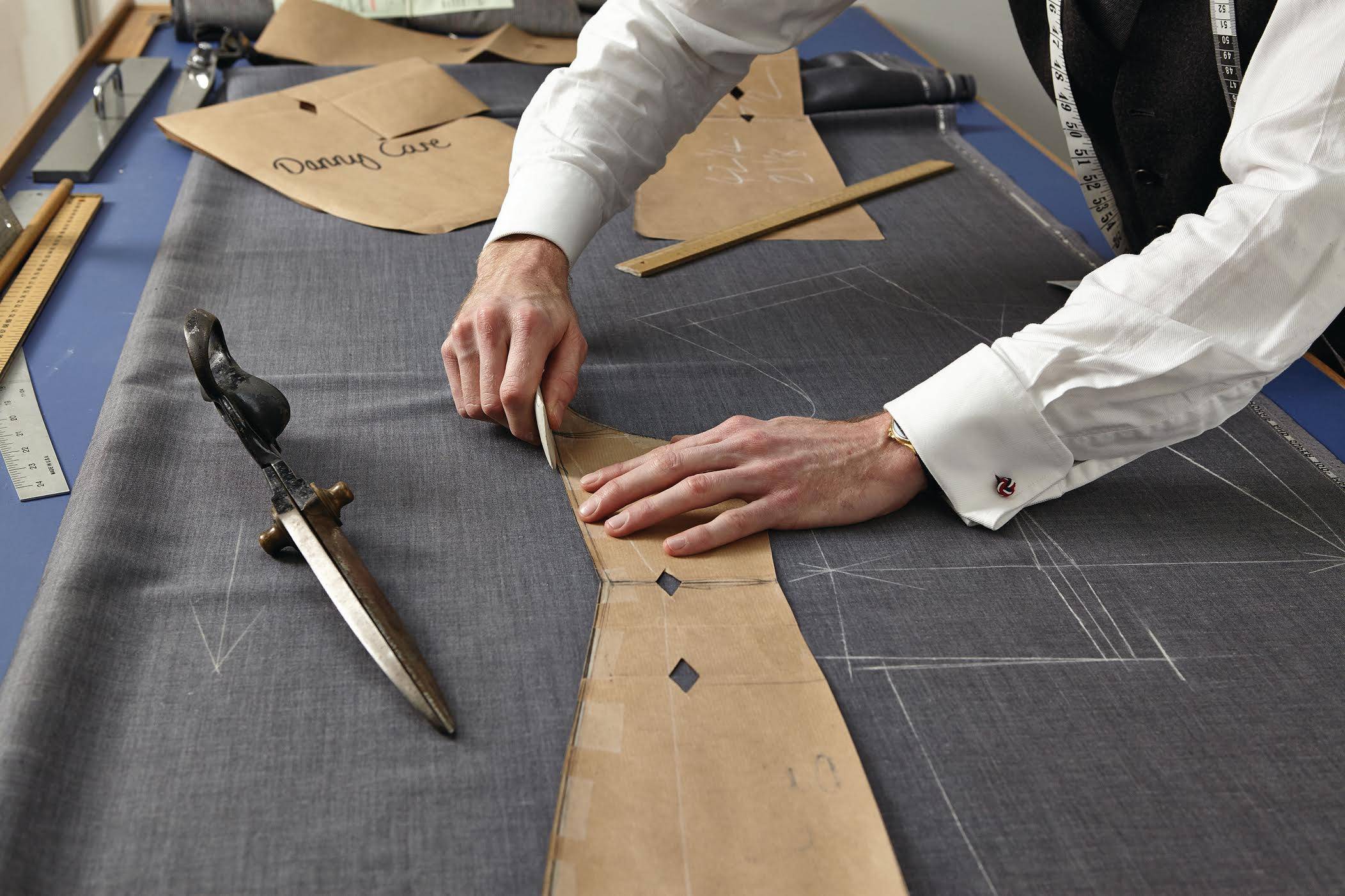 A cutter at work at Stowers London on Savile Row – but are bespoke suits really worth the expense? Photo: Handout
