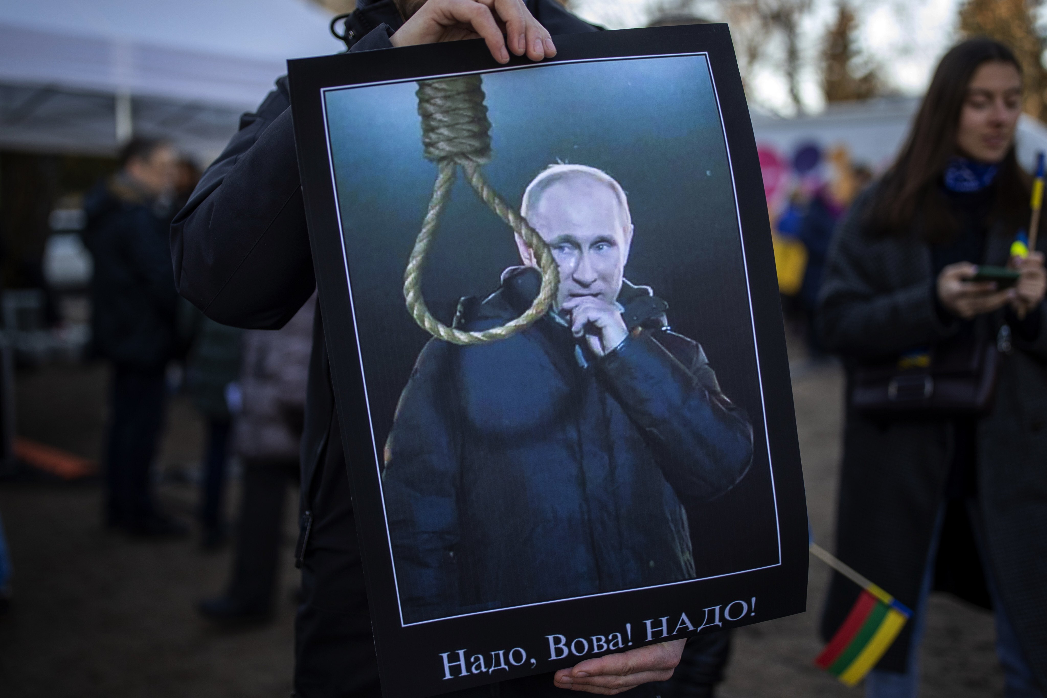 A demonstrator holds a placard depicting Russia’s Vladimir Putin during a protest in Vilnius, Lithuania. Photo: AP