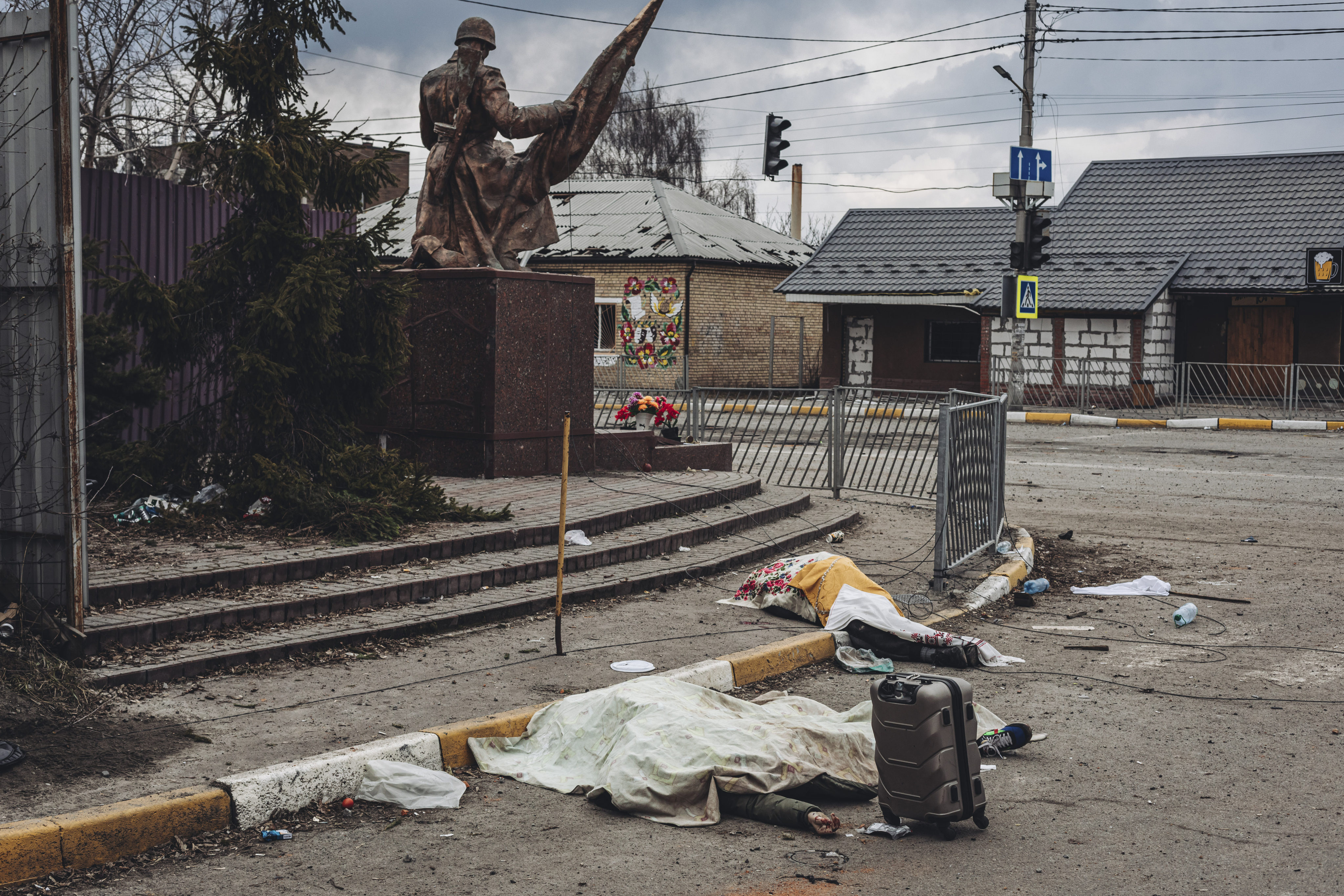 The dead bodies of people killed by Russian shelling lie covered in the street in the town of Irpin, Ukraine on Sunday. Photo: AP