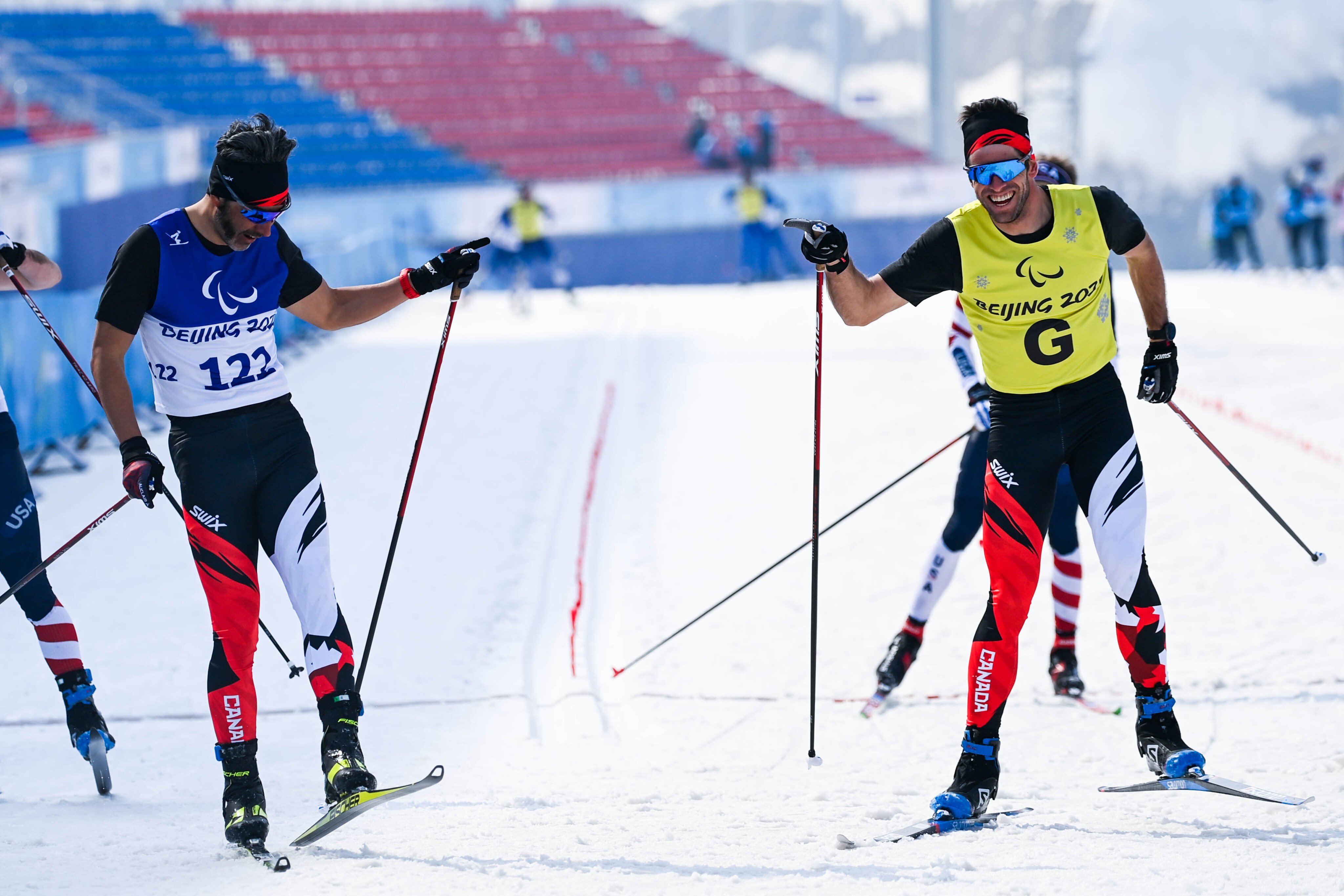 Gold medallist Brian McKeever (let) of Canada and his guide Russell Kennedy celebrate after the Para Cross-Country Skiing Men’s Sprint Sitting Free Technique Vision Impaired Final. Photo: Xinhua