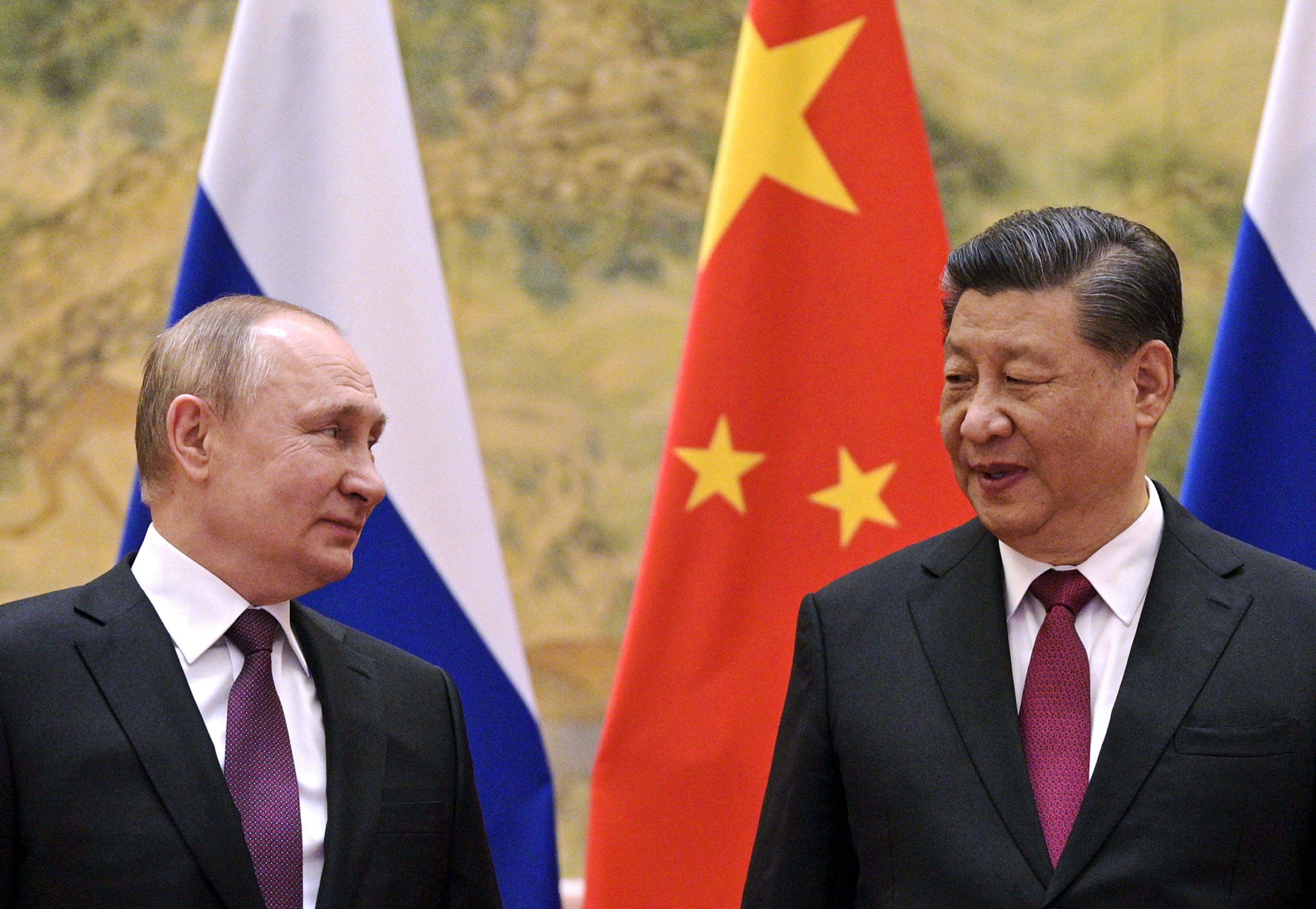 Russian President Vladimir Putin (left) and Chinese President Xi Jinping chat during their meeting in Beijing on February 4. Photo: AP