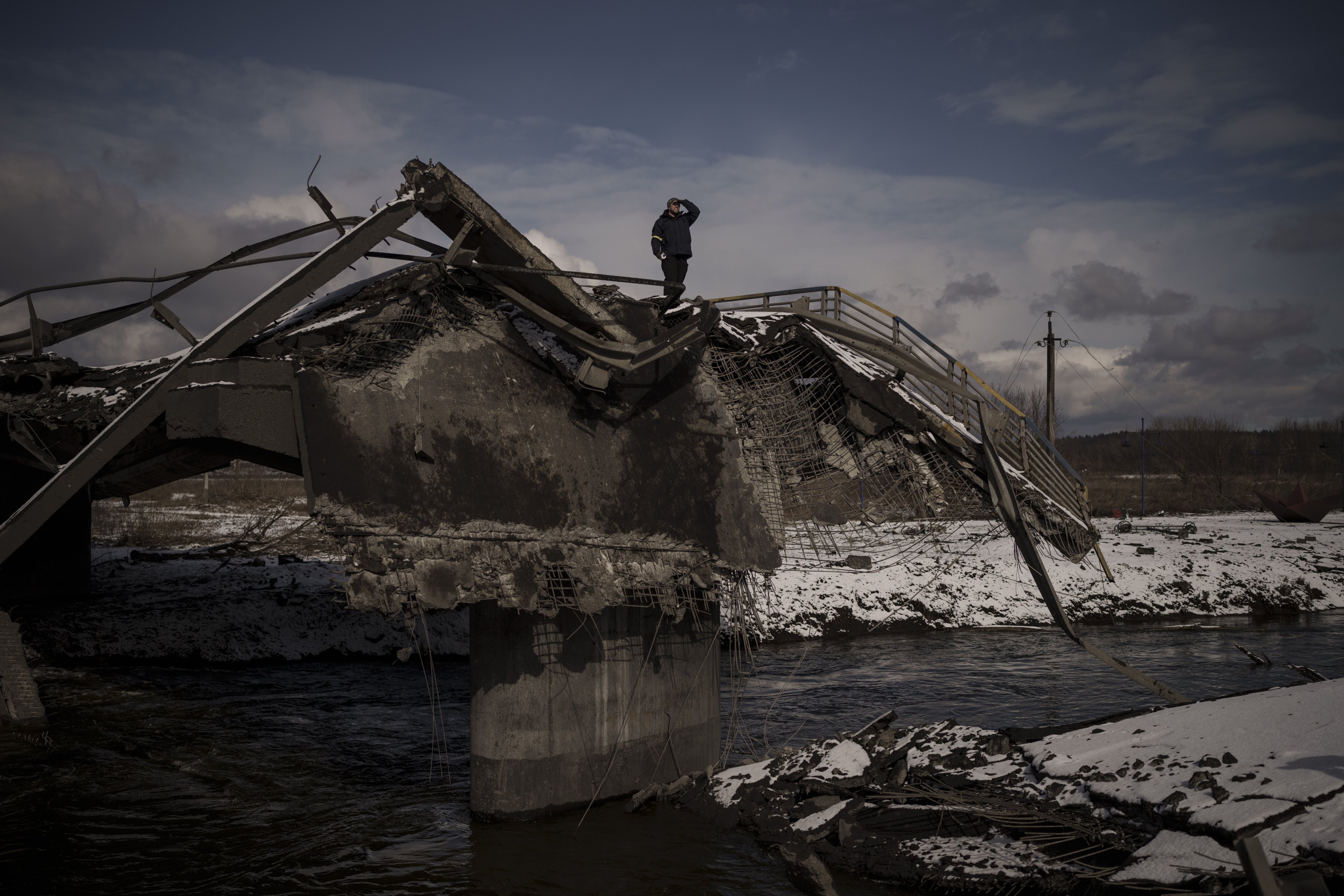 A man looks out from a destroyed bridge in Irpin, on the outskirts of Kyiv, Ukraine, on March 8. Photo: AP