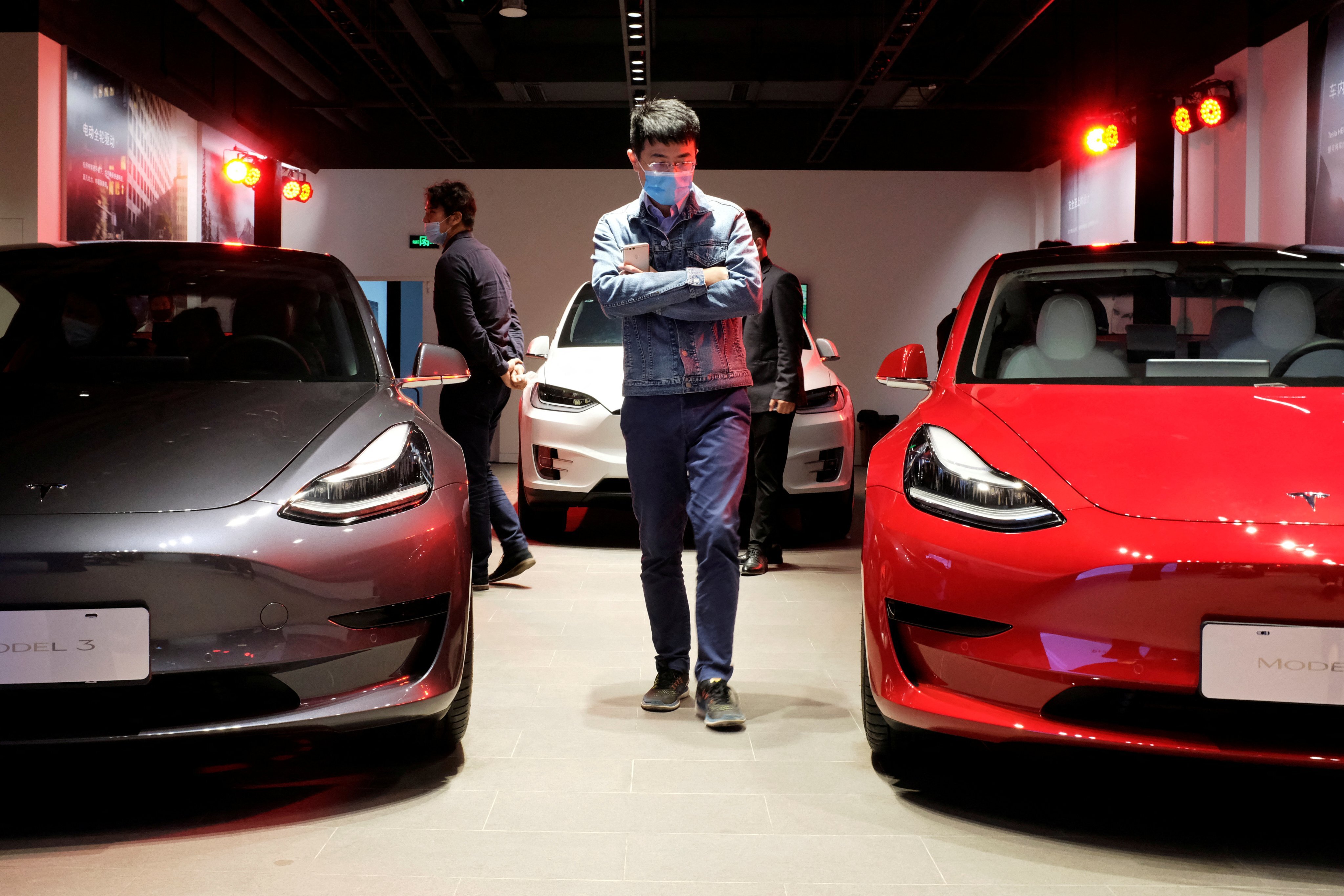 A consumer checks out Tesla cars at a showroom in Shanghai. Photo: Reuters