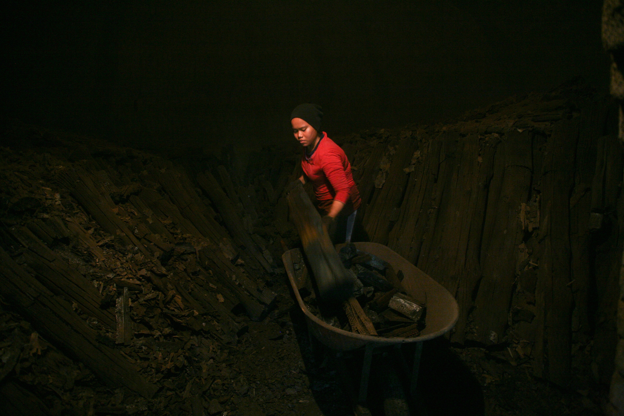 A worker collects charcoal after three weeks inside the kilns at a factory in Kuala Sepetang. Photo: Mohd Samsul Mohd Said/Getty Images