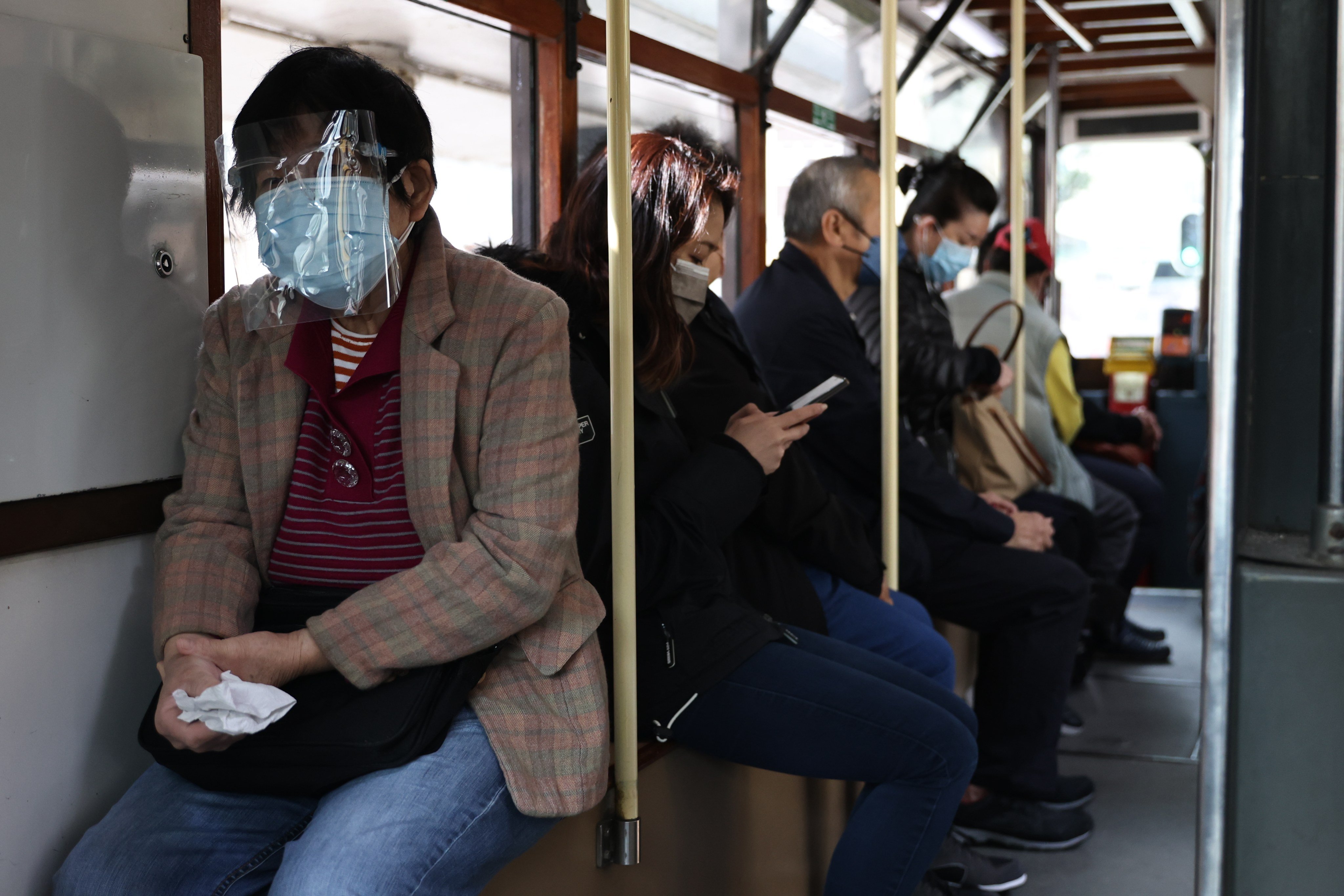 A tram passenger is masked-up as Hong Kong struggles with its fifth wave of infections. Photo: K. Y. Cheng