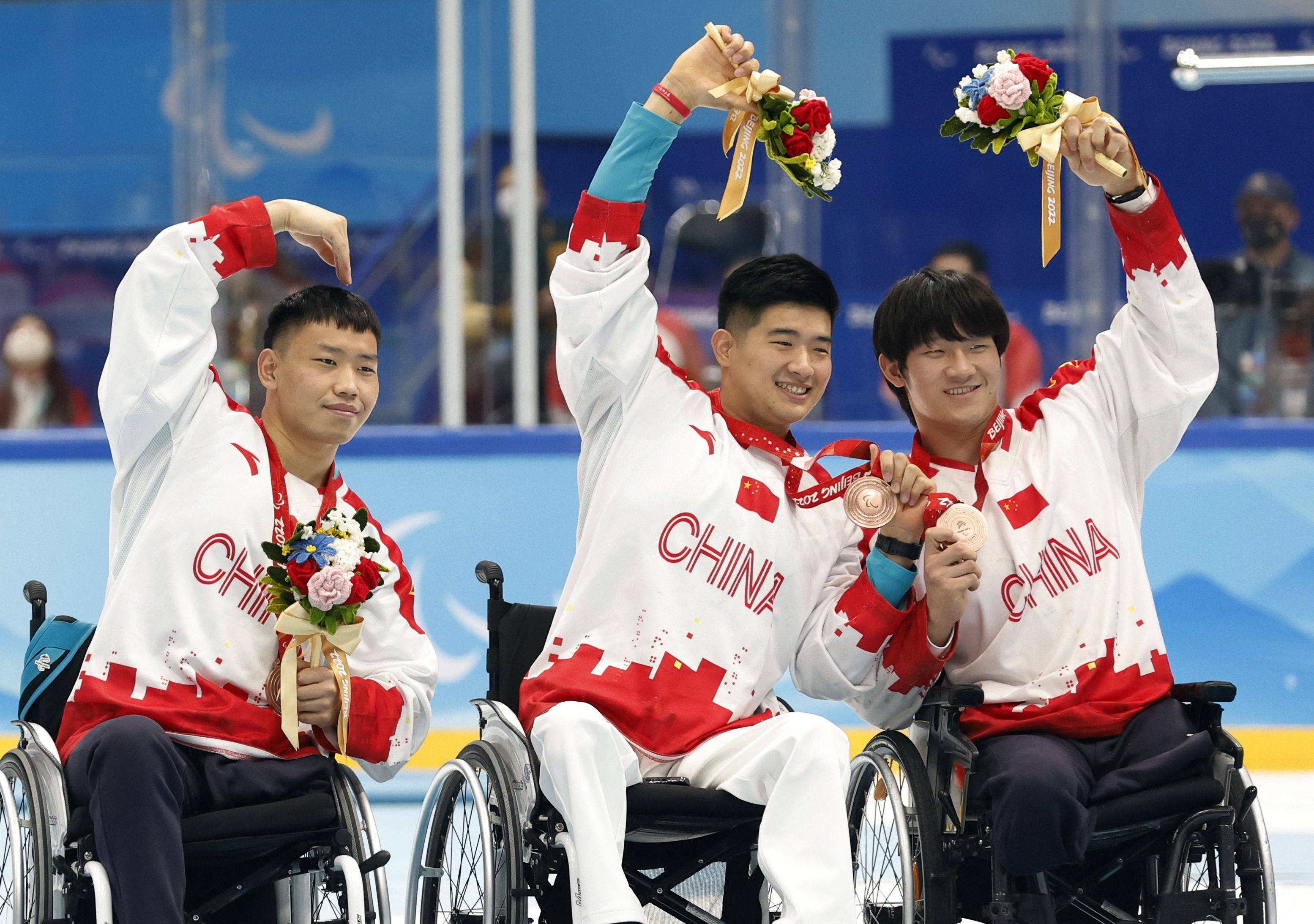 Members of China’s para ice hockey team celebrate with their bronze medals. Photo: Reuters
