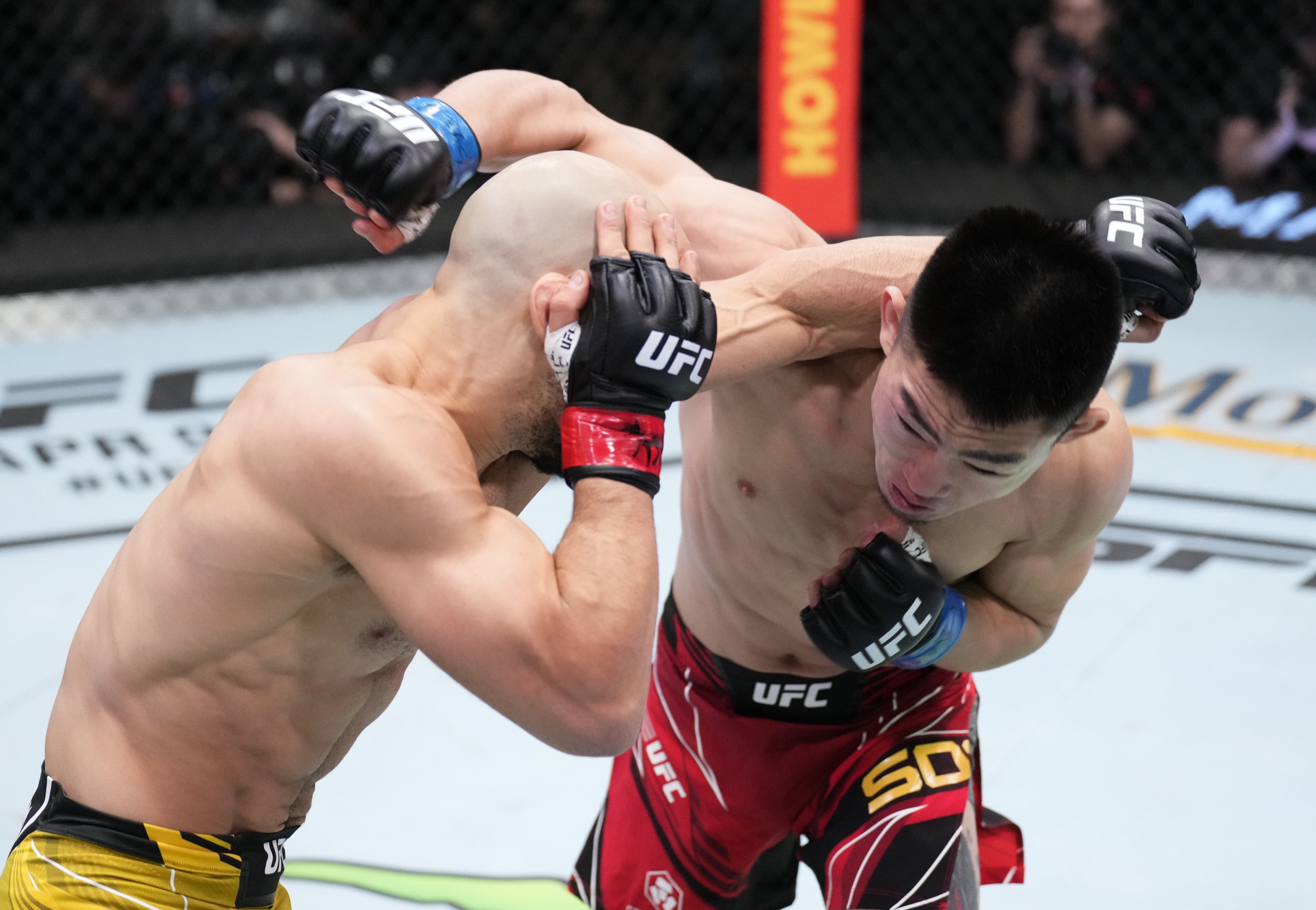 Song Yadong of China (right) and Marlon Moraes of Brazil trade punches in their bantamweight fight on March 12, 2022 in Las Vegas, Nevada. Photo: Chris Unger/Zuffa LLC