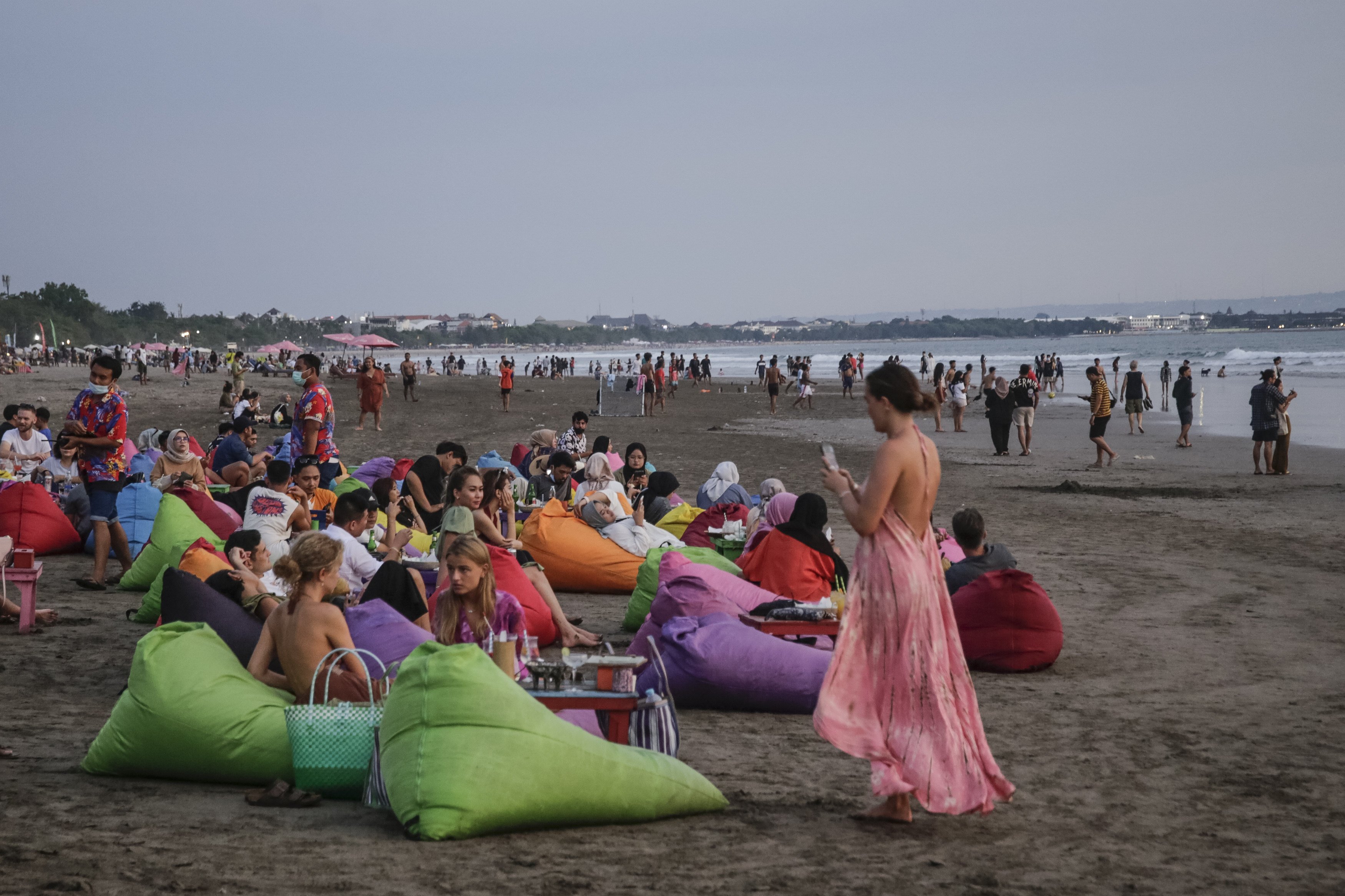 Tourists on Canggu Beach, Bali, Indonesia on March 12, 2022. The current requirements for foreign travellers to Bali have been criticised for being too much. Photo: Getty Images