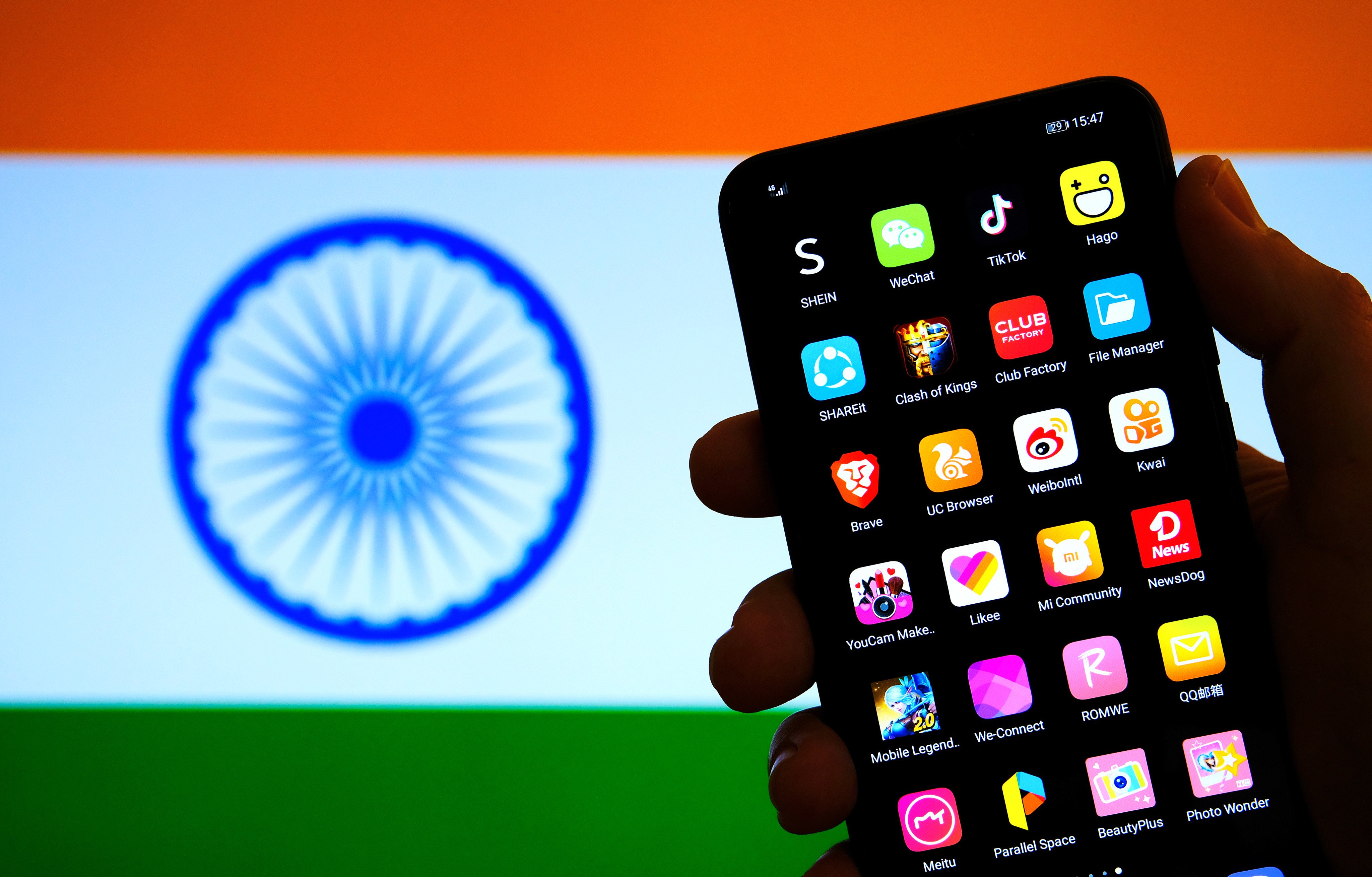 TikTok and other Chinese apps banned in India are seen on a smartphone screen with the Indian flag in the background.
Photo: Shutterstock