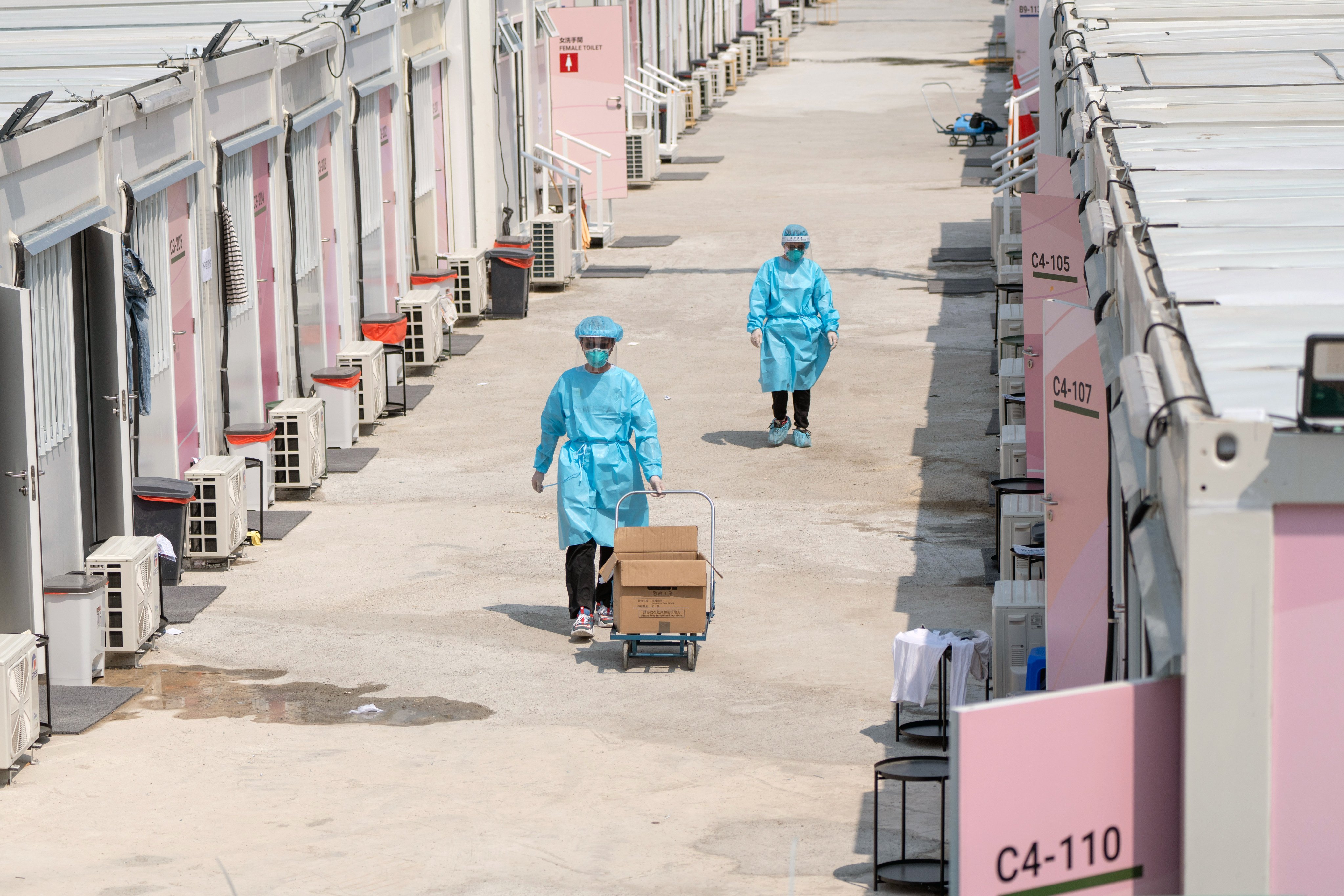Health care workers in protective gear are seen at a Covid-19 isolation facility in Hong Kong on Tuesday. Photo: Bloomberg