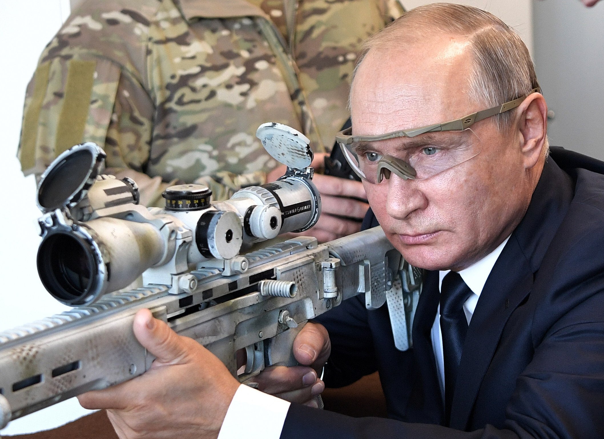 Vladimir Putin aims a sniper rifle while visiting a military exhibition near Moscow, Russia, in September 2018. Photo: Kremlin Pool Photo via AP