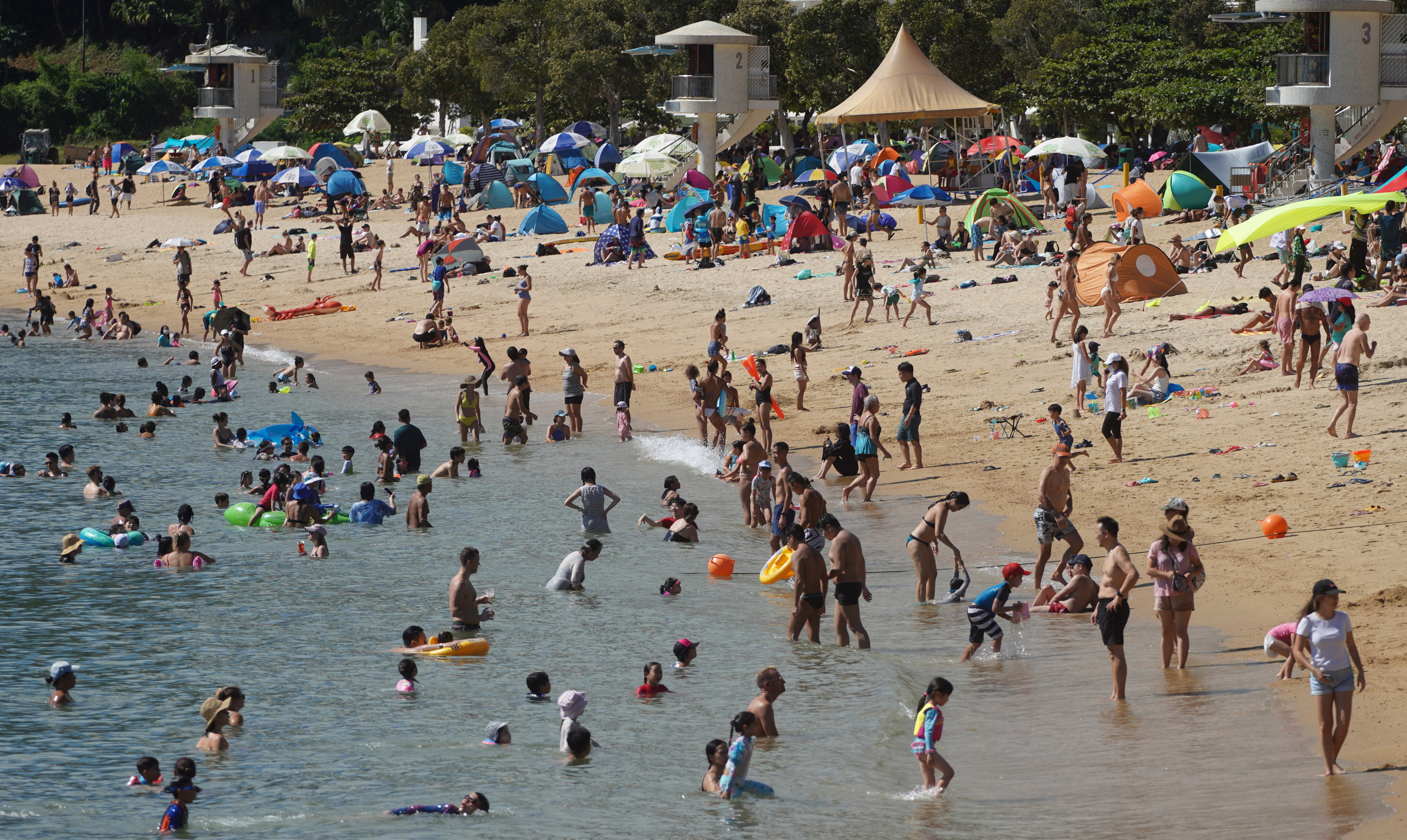 Hong Kong’s crowded public beaches amid the fifth wave of the coronavirus have drawn scorn across the border, where residents are under strict lockdowns. Photo: Winson Wong