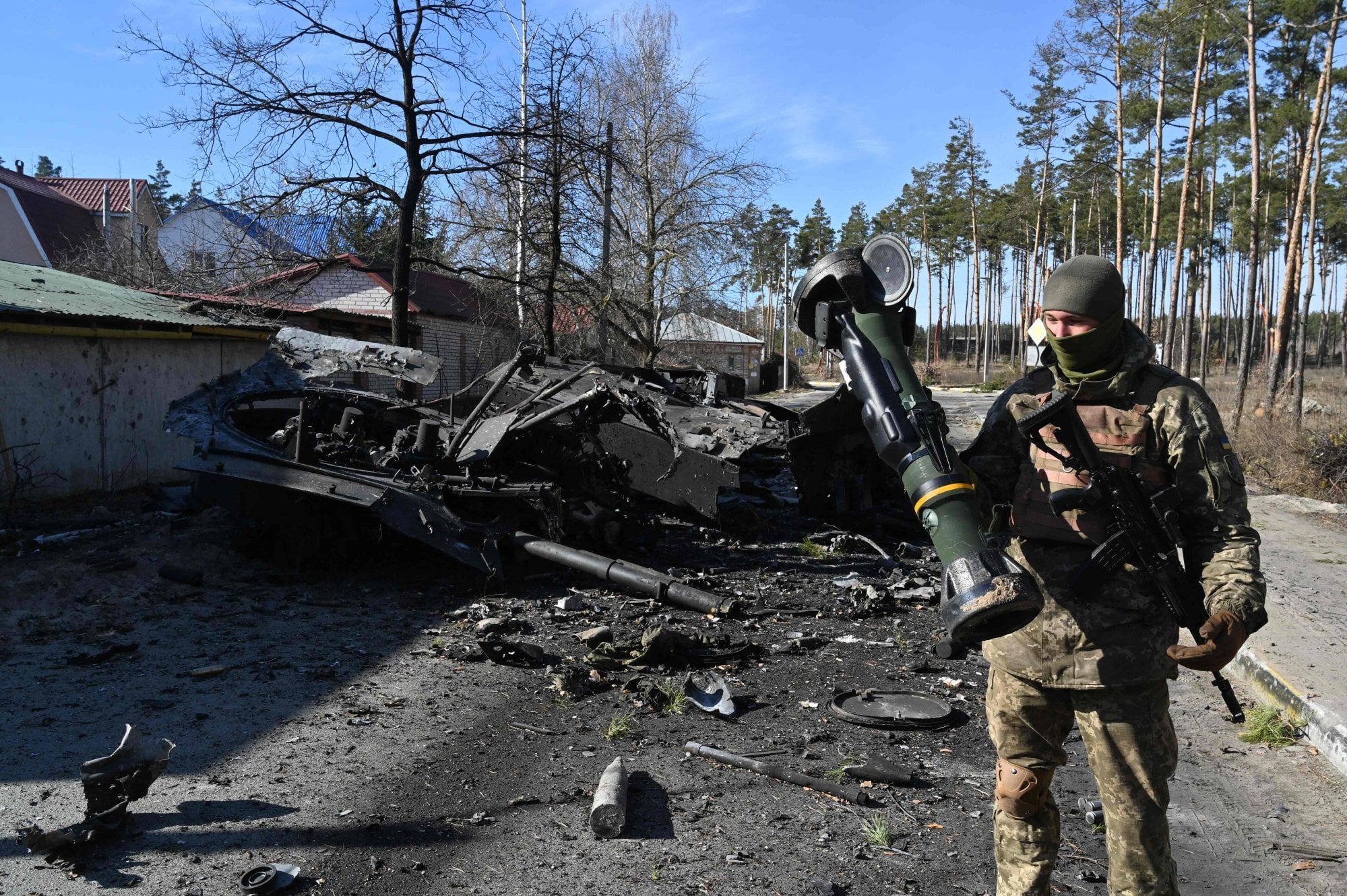 A Ukrainian soldier holds a NLAW that was used to destroy a Russian armoured vehicle, north of Kyiv. Photo: AFP