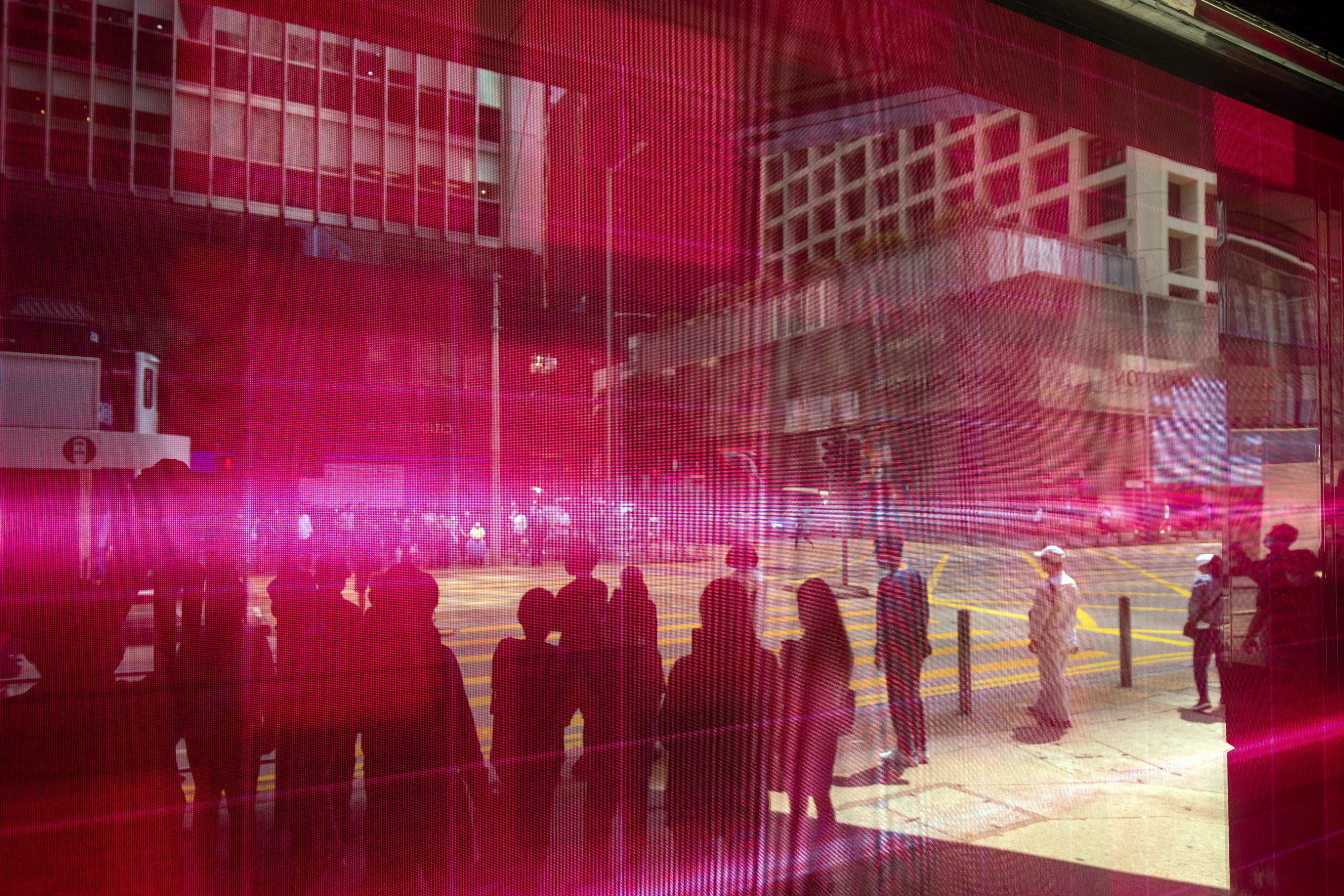 Pedestrians reflected in an electronic screen displaying stock figures in Hong Kong on March 15,. Photo: Bloomberg