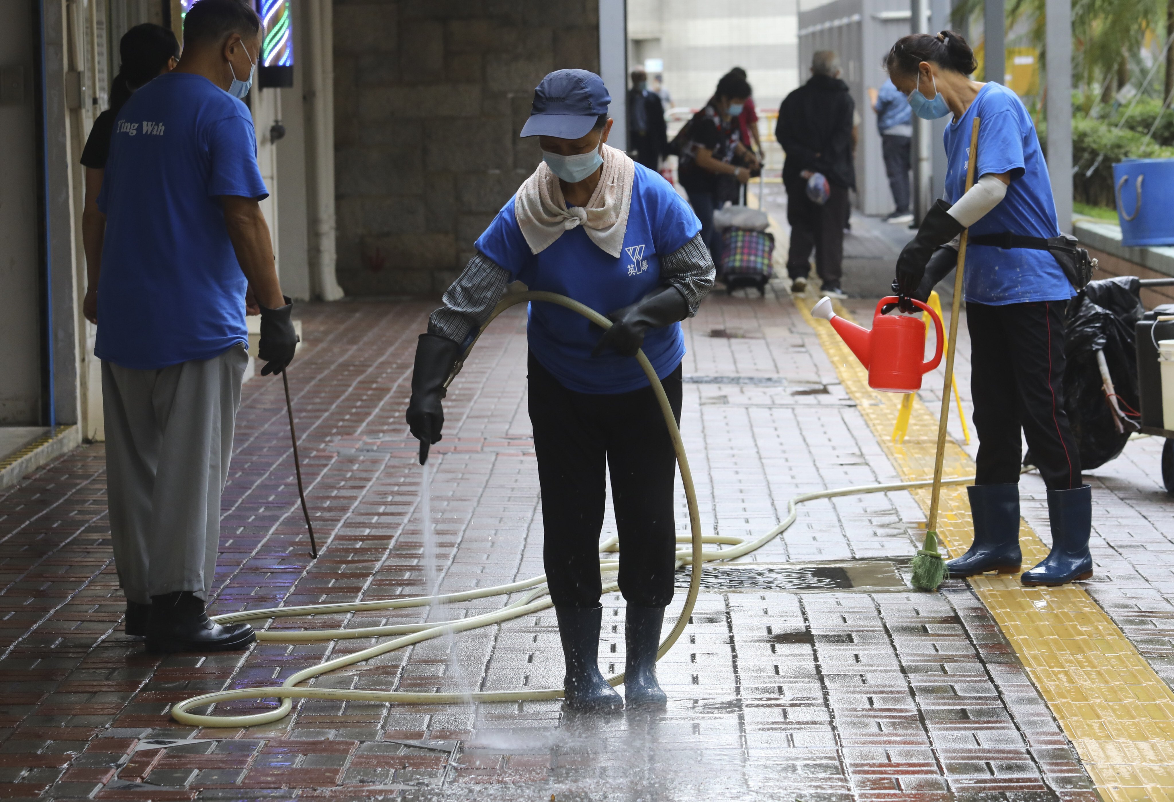 Cleaners spray an open area in Lai King Estate on October 29, 2020. Climate change means water is an ever more precious resource. Photo: Dickson Lee 
