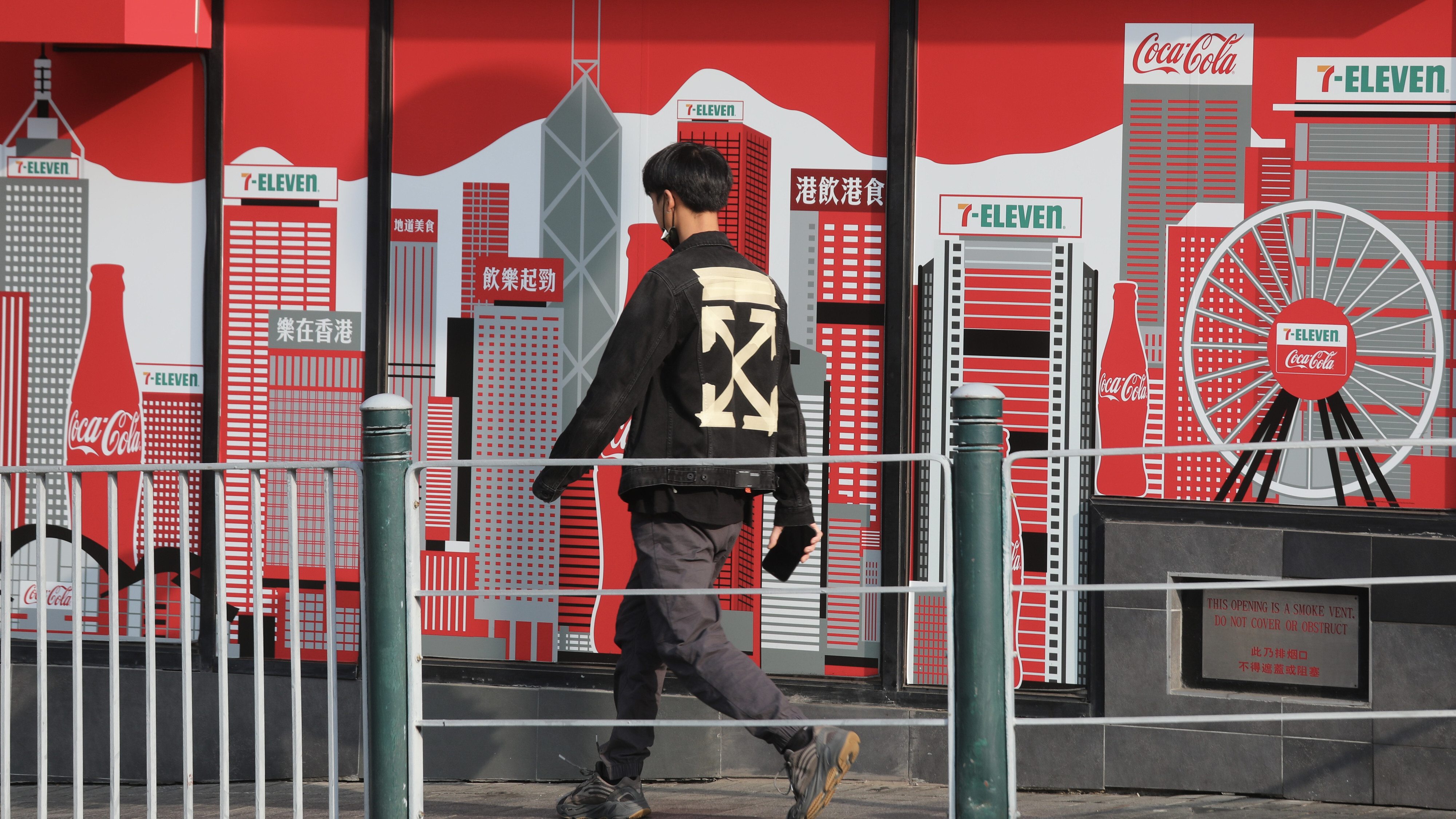 A pedestrian passes a mural of the Hong Kong skyline in Jordan. Photo: Xiaomei Chen